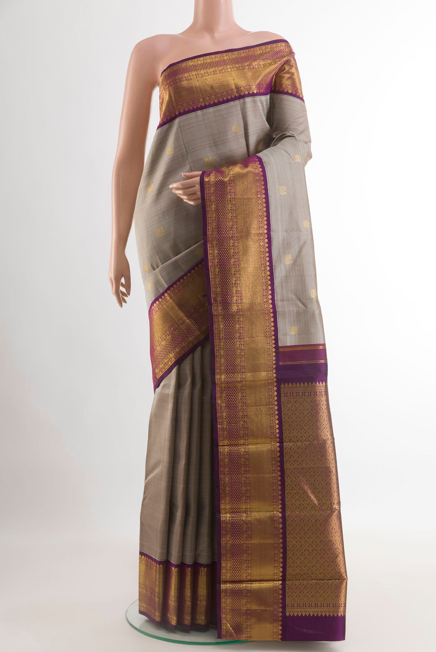 Grey Kanjivaram Silk Saree with Zari Butta on the body and Zari Border.  displayed on a mannequin