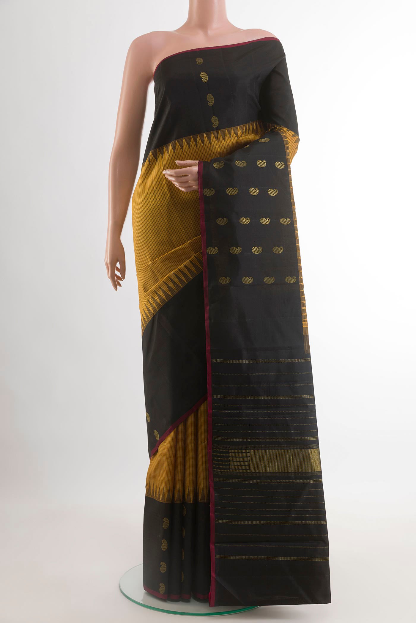 Yellow Kanjivaram Silk Saree with Checked design on the body and Plain Border.  displayed on a mannequin