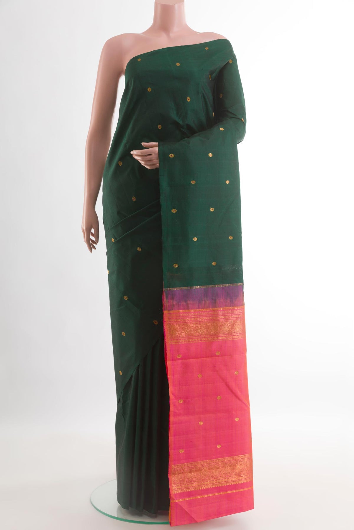 Bottle Green Kanchipuram Silk Saree with Zari Butta on the body and Without Border.  displayed on a mannequin