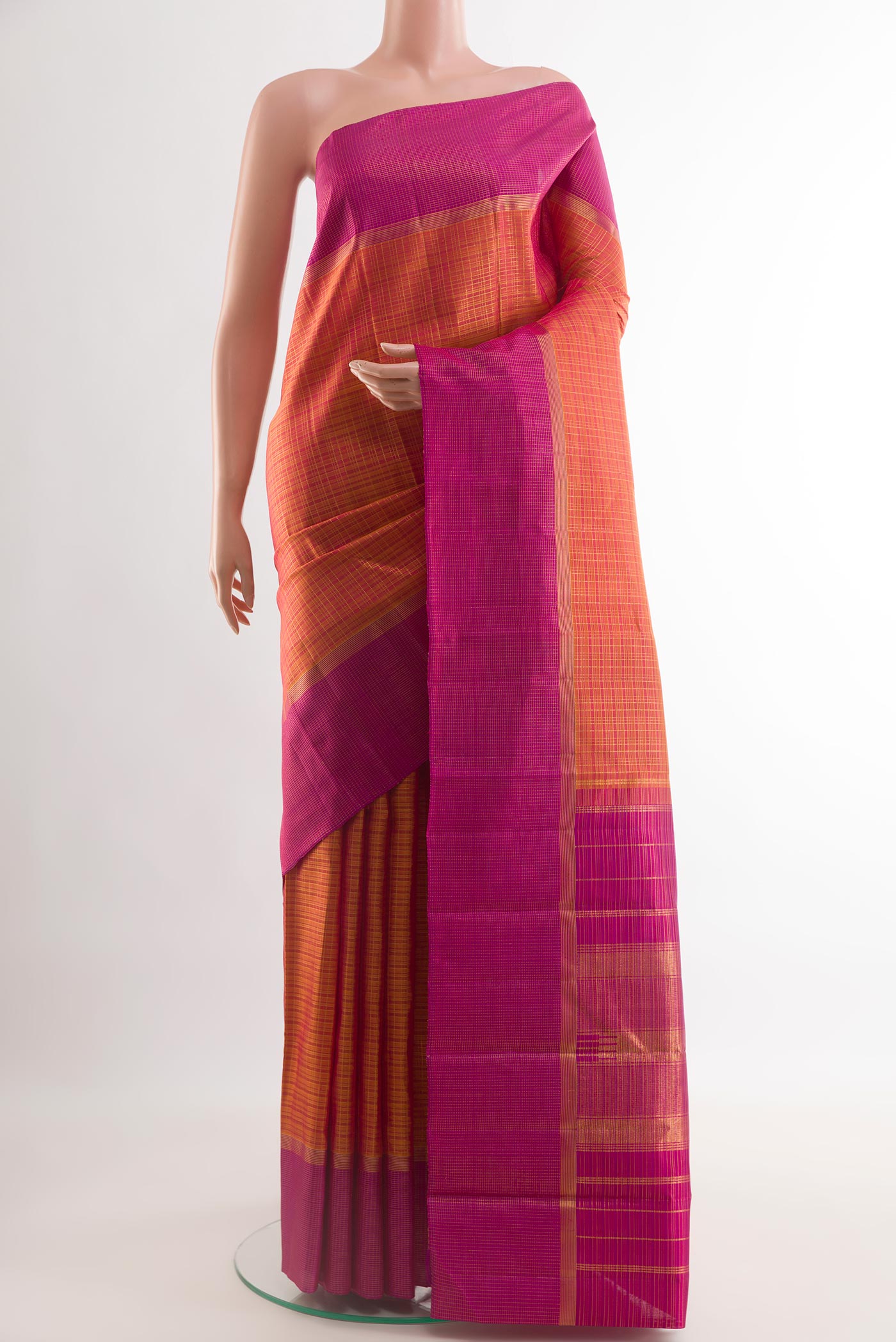Brick Orange Kanjivaram Silk Saree with Checked design on the body and Zari Border.  displayed on a mannequin