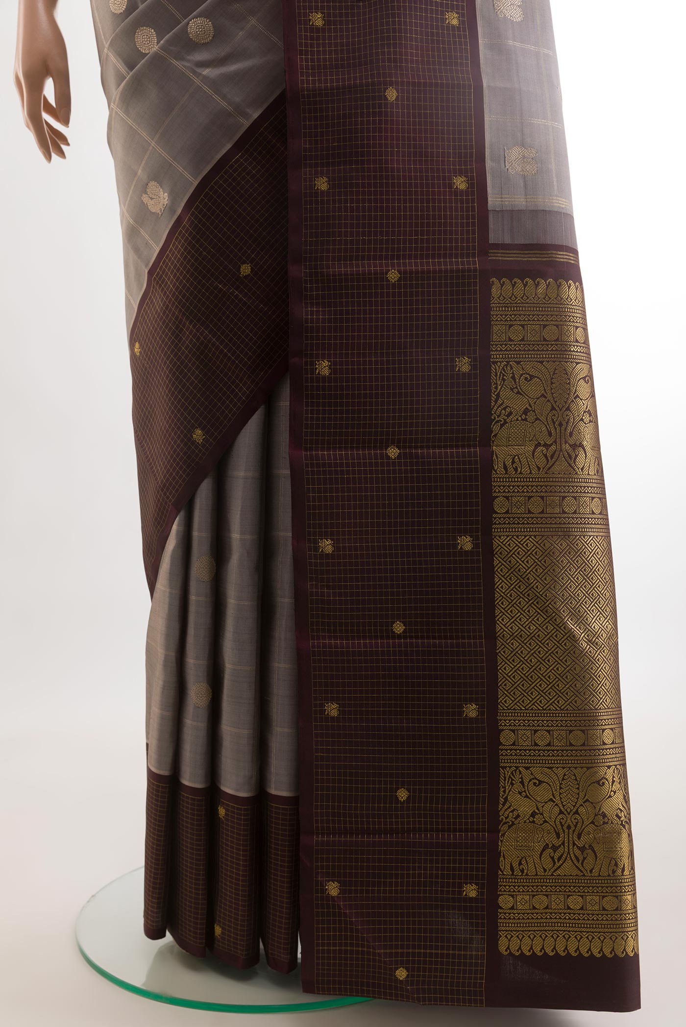 Pleats and pallu of Grey Kanjivaram Silk Saree with Checked design on the body and Checks Border. 