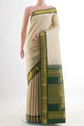 Off White Kanchipuram Silk Saree with Zari Butta on the body and Zari Border.  displayed on a mannequin