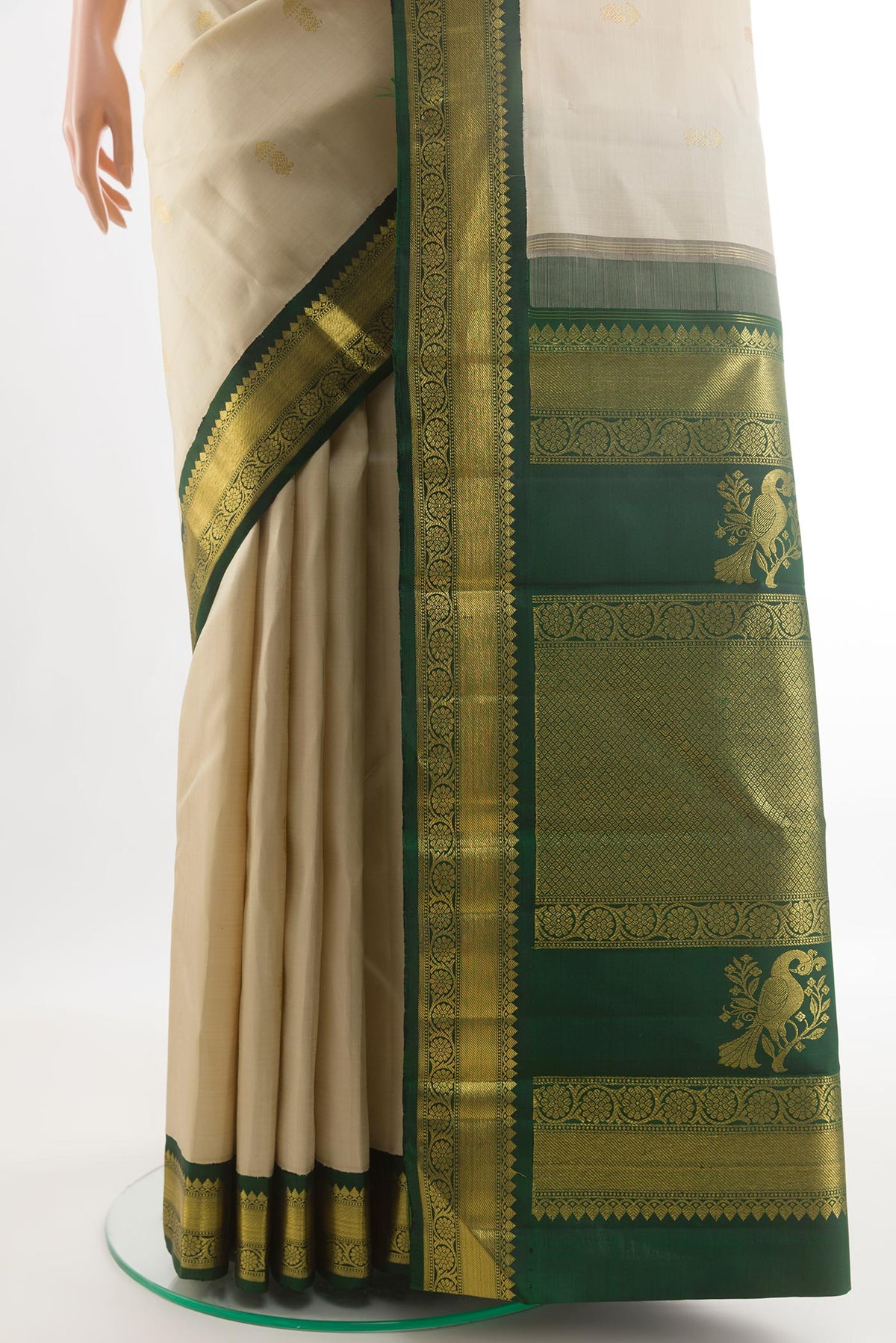 Pleats and pallu of Off White Kanchipuram Silk Saree with Zari Butta on the body and Zari Border. 