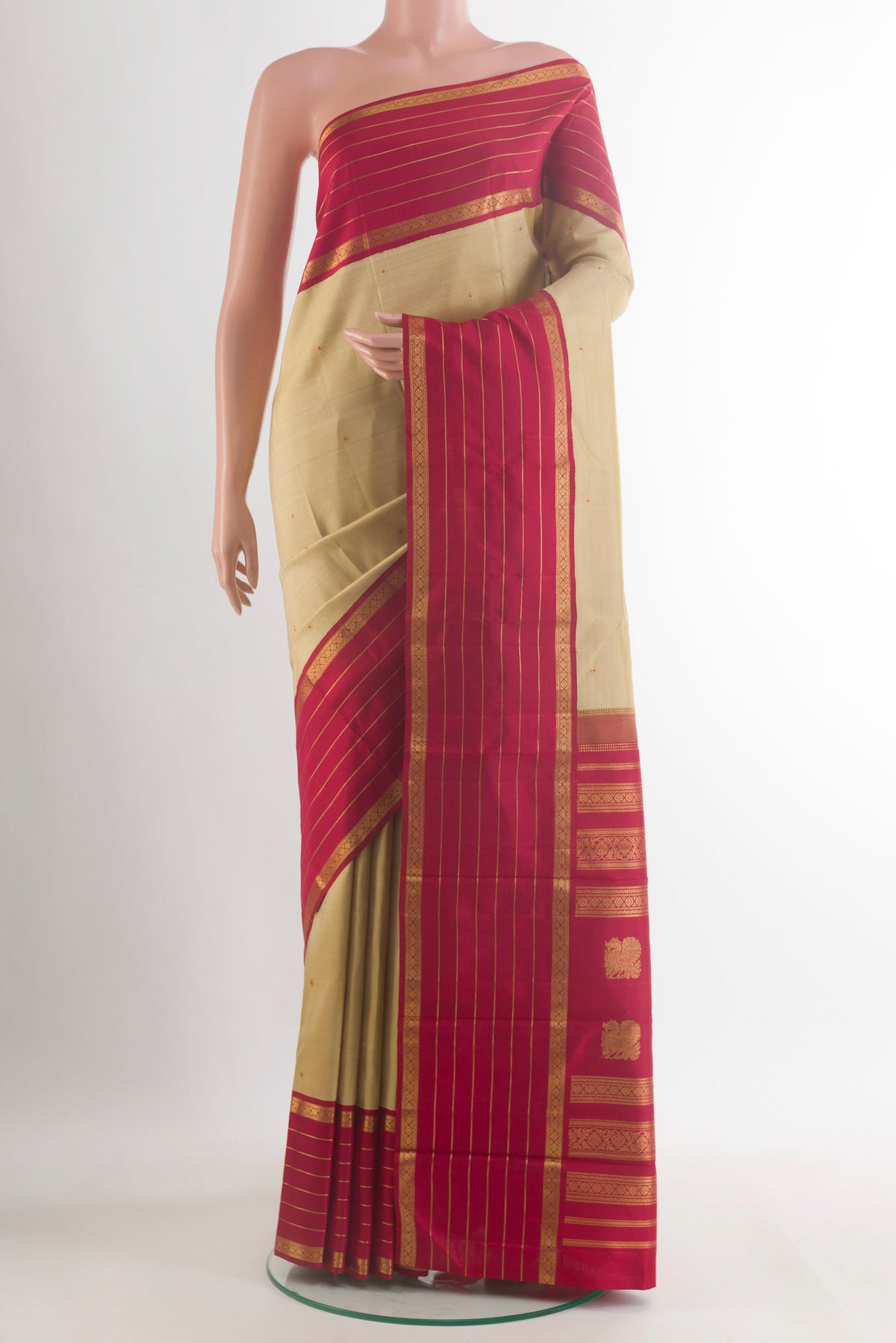 Pure Silk Beige Kanchipuram Saree with Zari Butta on the body and Zari Border.  displayed on a mannequin