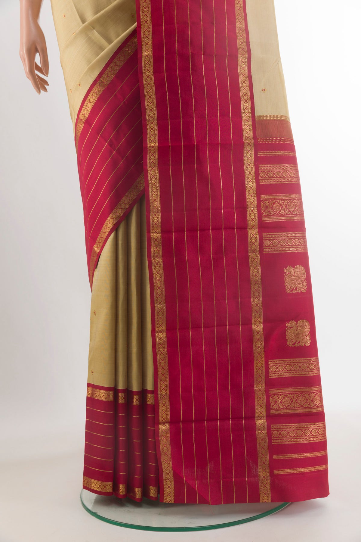 Pleats and pallu of Pure Silk Beige Kanchipuram Saree with Zari Butta on the body and Zari Border. 