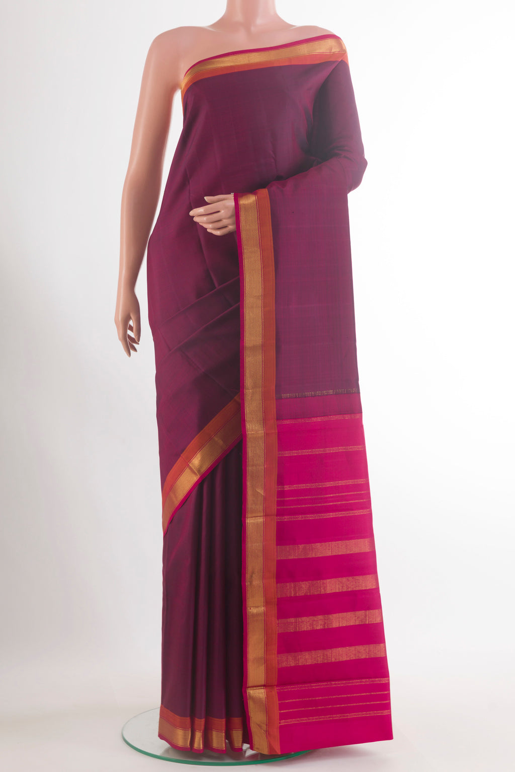 Pure Silk Maroon Kanjivaram Saree with Plain Body and Zari Border.  displayed on a mannequin