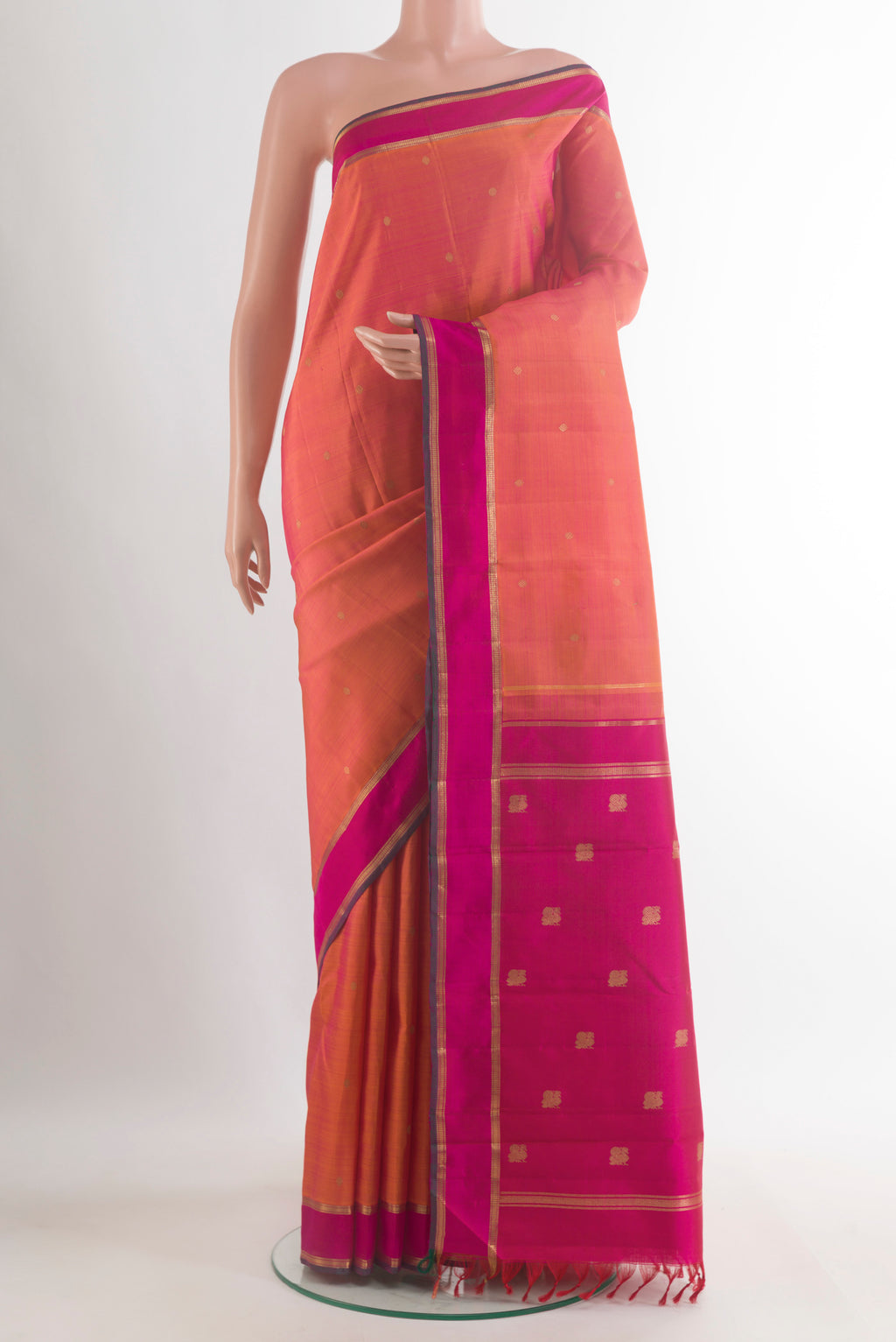 Pure Silk Pure Zari Orange Kanjivaram Saree with Zari Butta on the body and Zari Border.  displayed on a mannequin