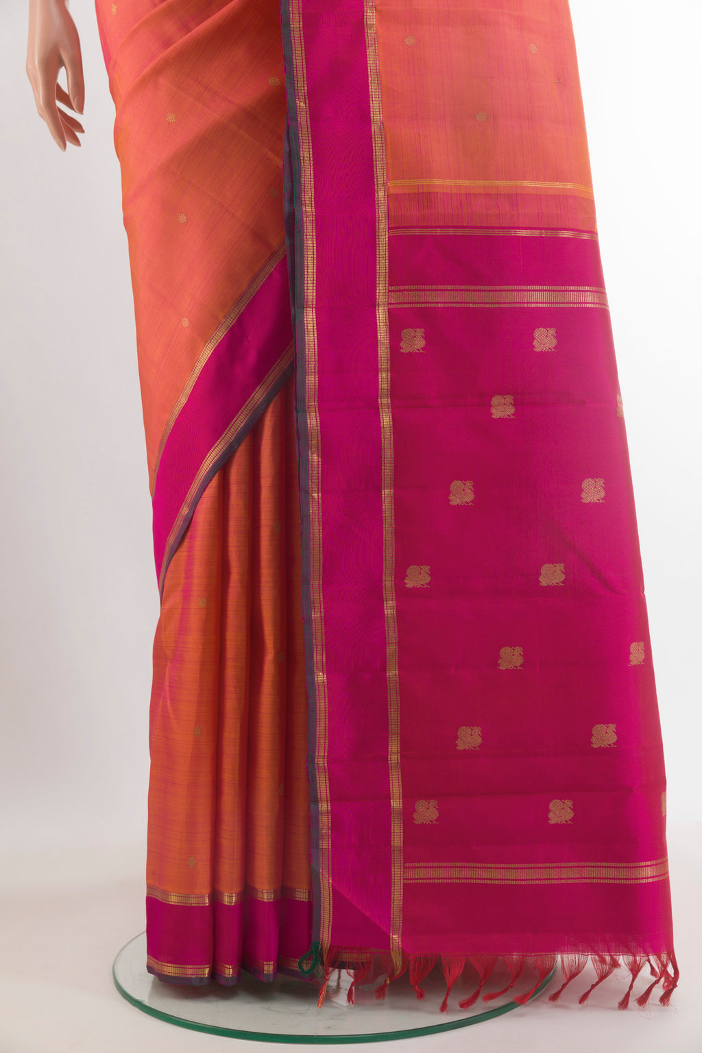 Pleats and pallu of Pure Silk Pure Zari Orange Kanjivaram Saree with Zari Butta on the body and Zari Border. 