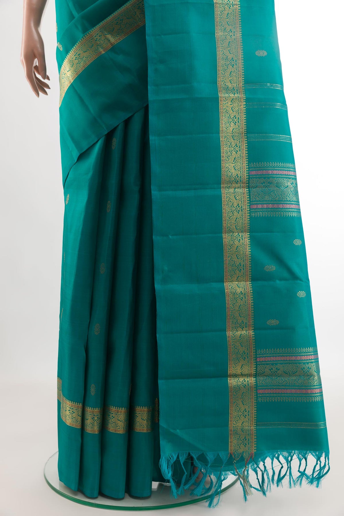 Pleats and pallu of Peacock Blue Kanchipuram Silk Saree with Zari Butta on the body and Zari Border. 