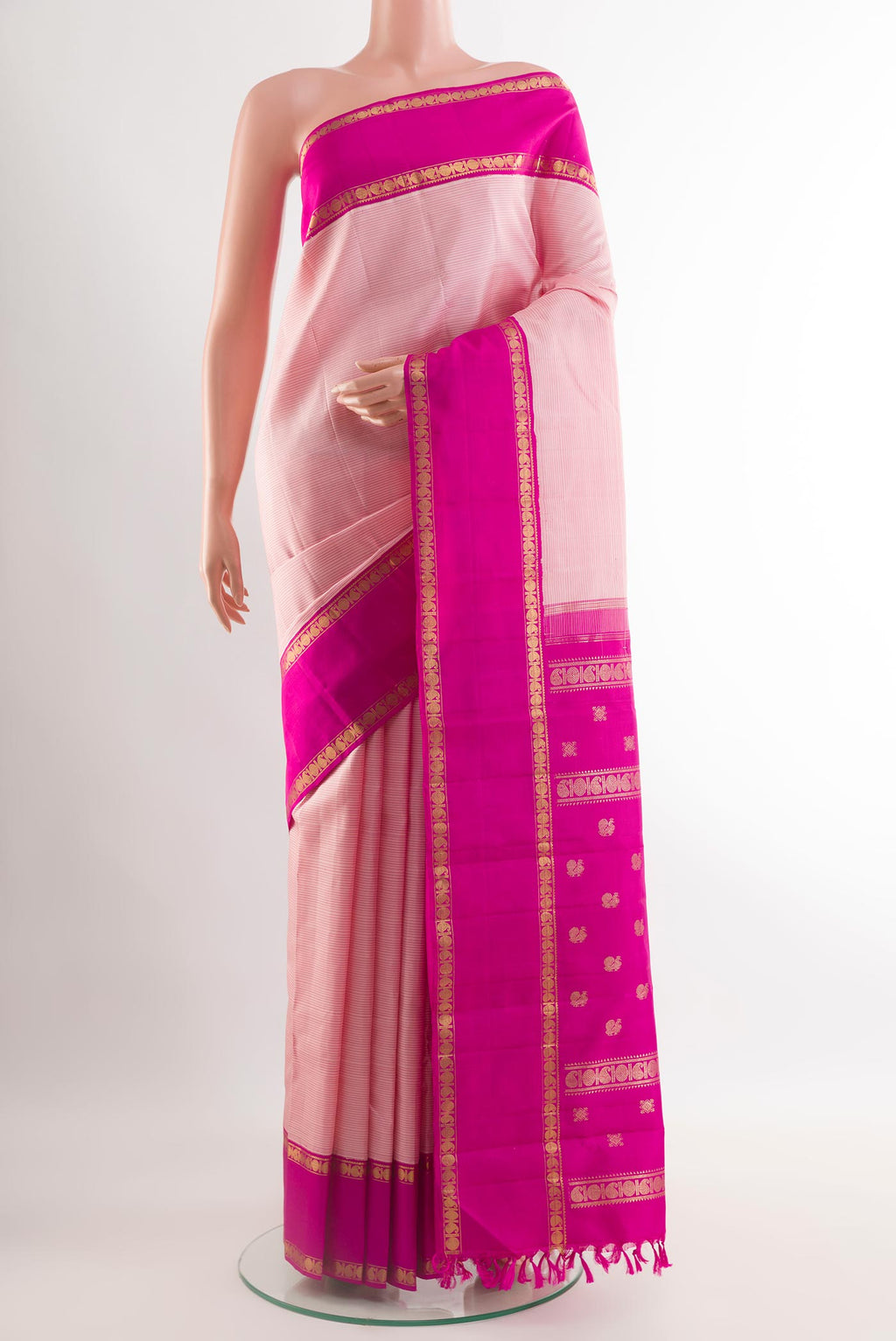Rose pink Kanchipuram Silk Saree with Stripes on the body and Zari Border.  displayed on a mannequin