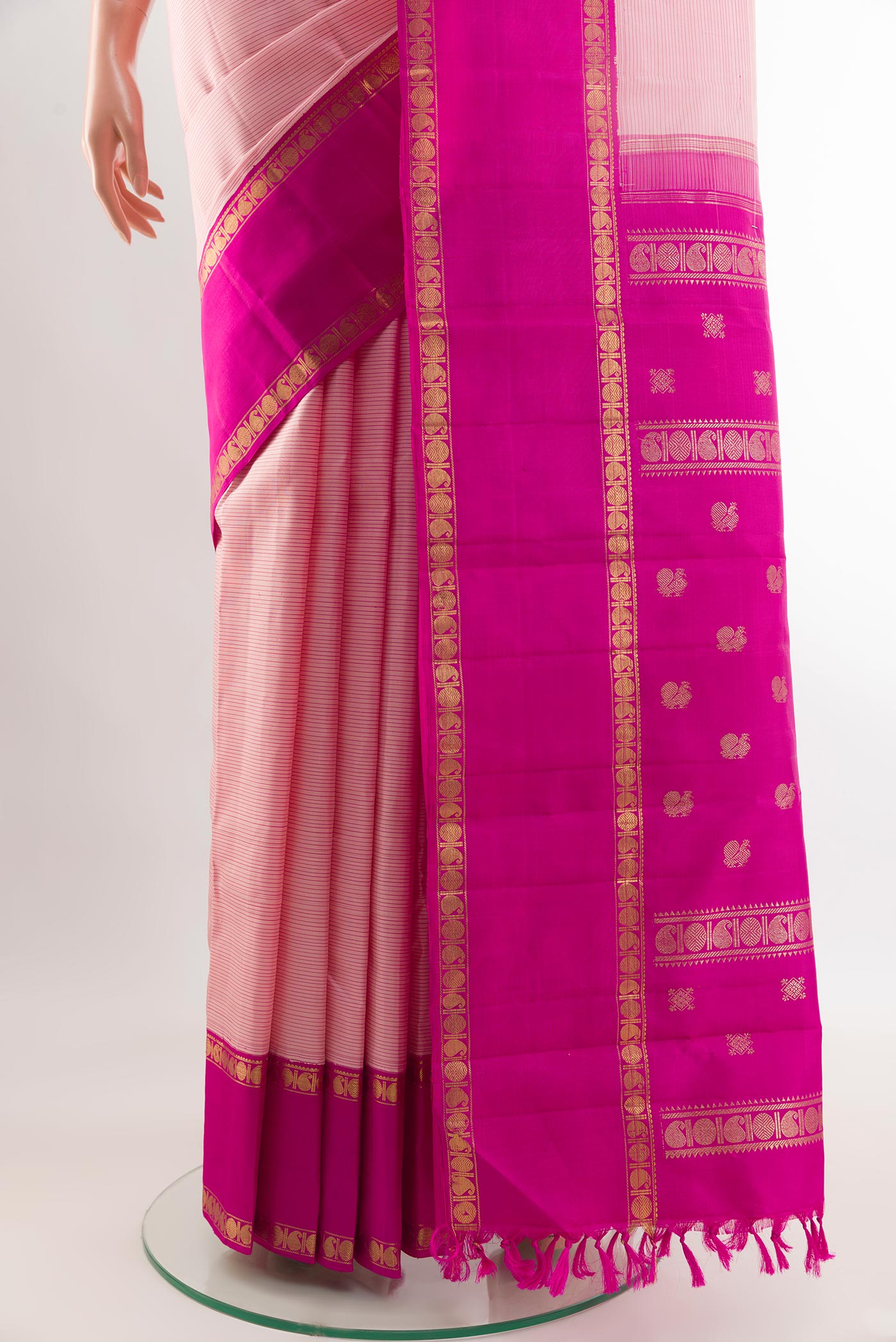 Pleats and pallu of Rose pink Kanchipuram Silk Saree with Stripes on the body and Zari Border. 