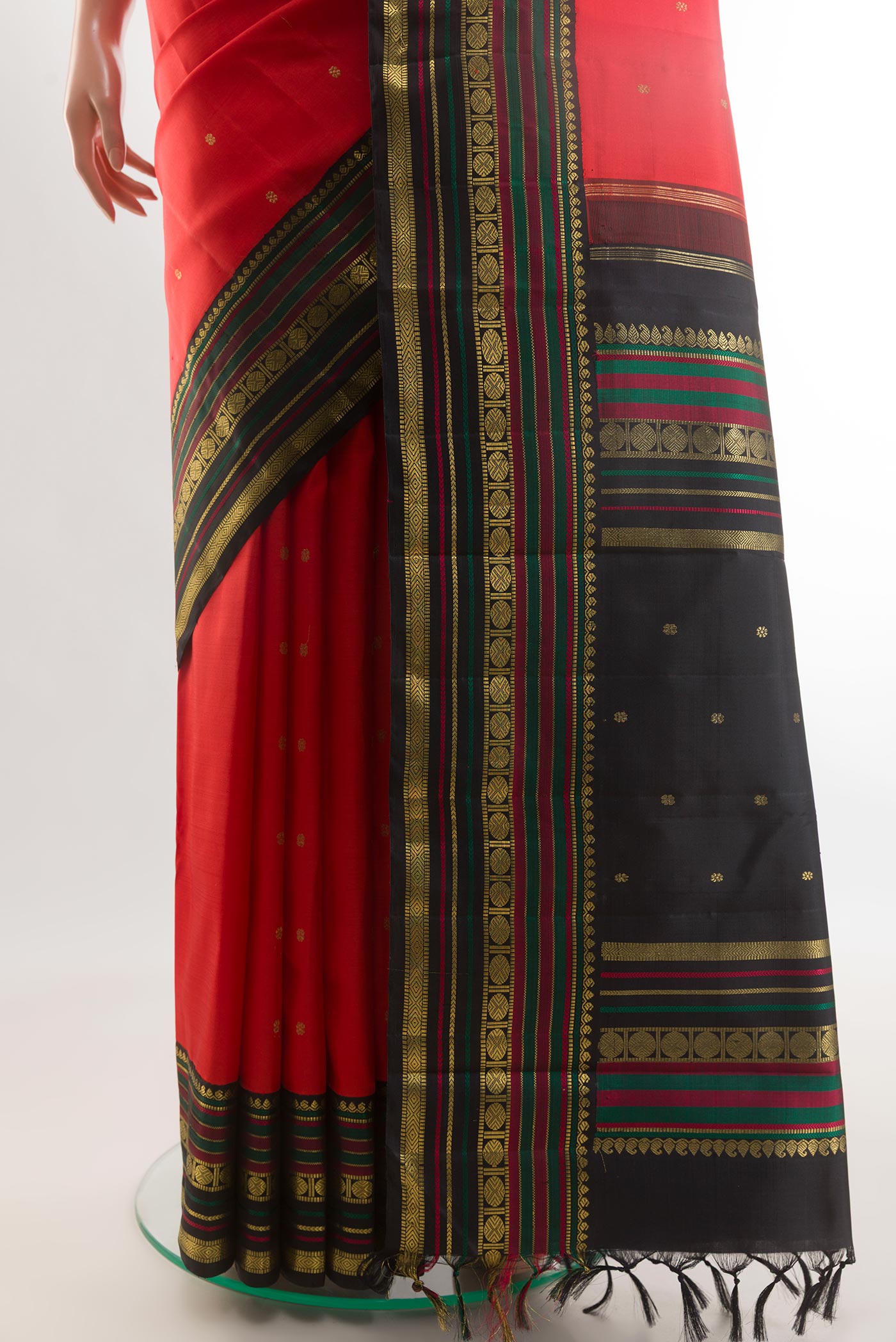 Pleats and pallu of Red Kanchipuram Silk Saree with Zari Butta on the body and Zari Border. 