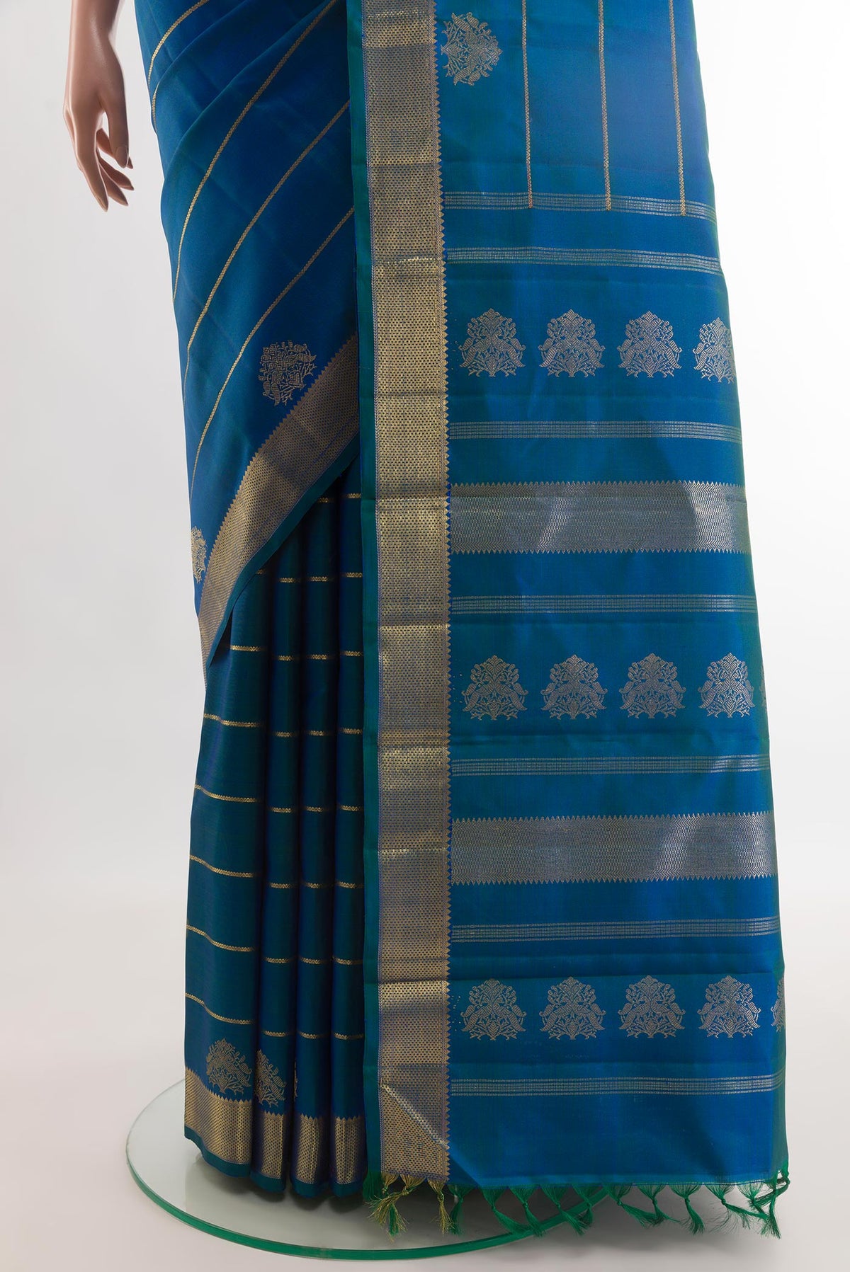 Pleats and pallu of Peacock Blue Kanchipuram Silk Saree with Stripes on the body and Zari Border. 