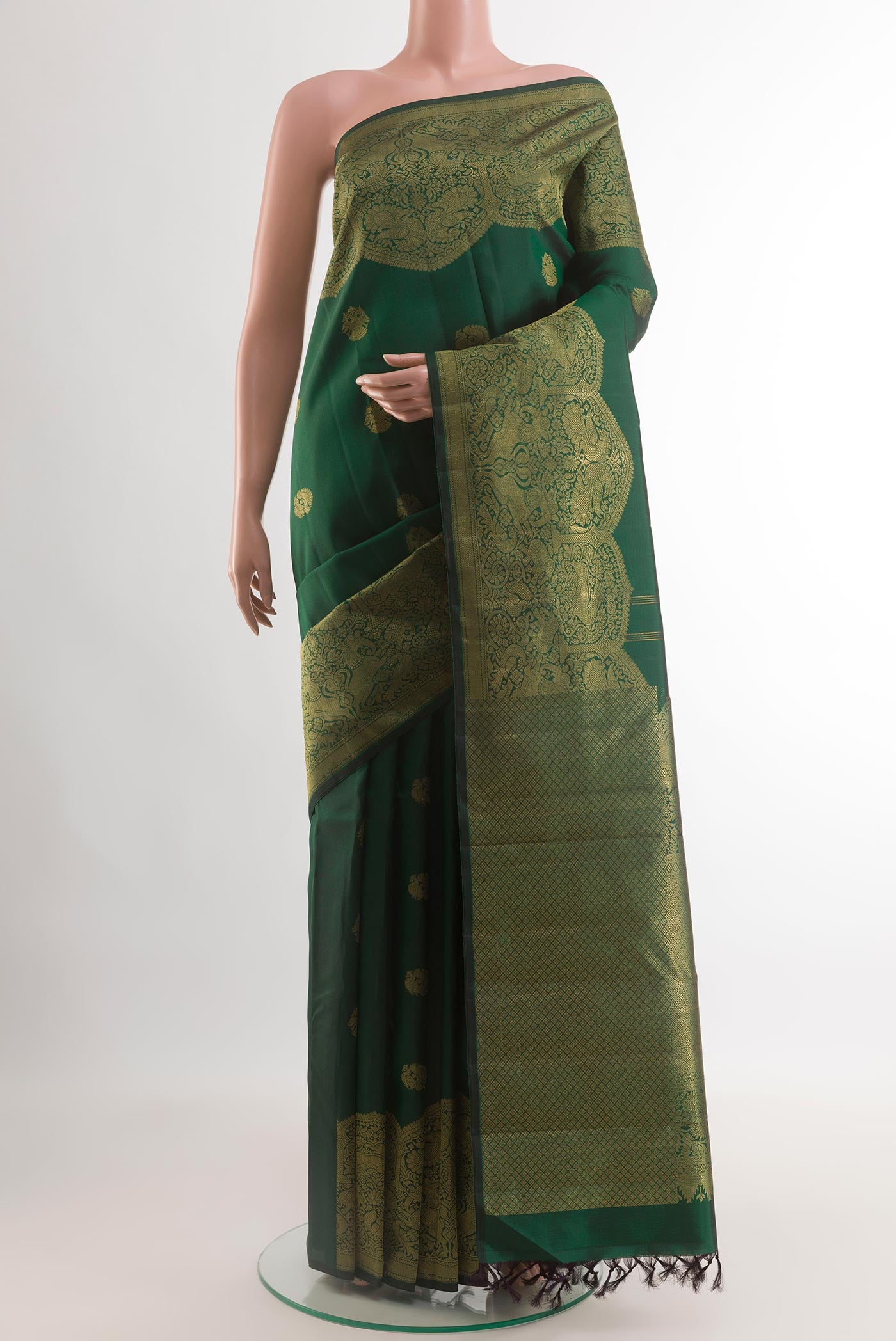 Bottle Green Kanchipuram Silk Saree with Zari Butta on the body and Fancy Border.  displayed on a mannequin