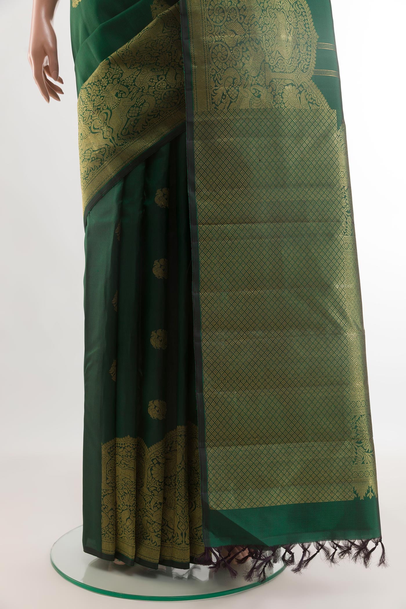 Pleats and pallu of Bottle Green Kanchipuram Silk Saree with Zari Butta on the body and Fancy Border. 