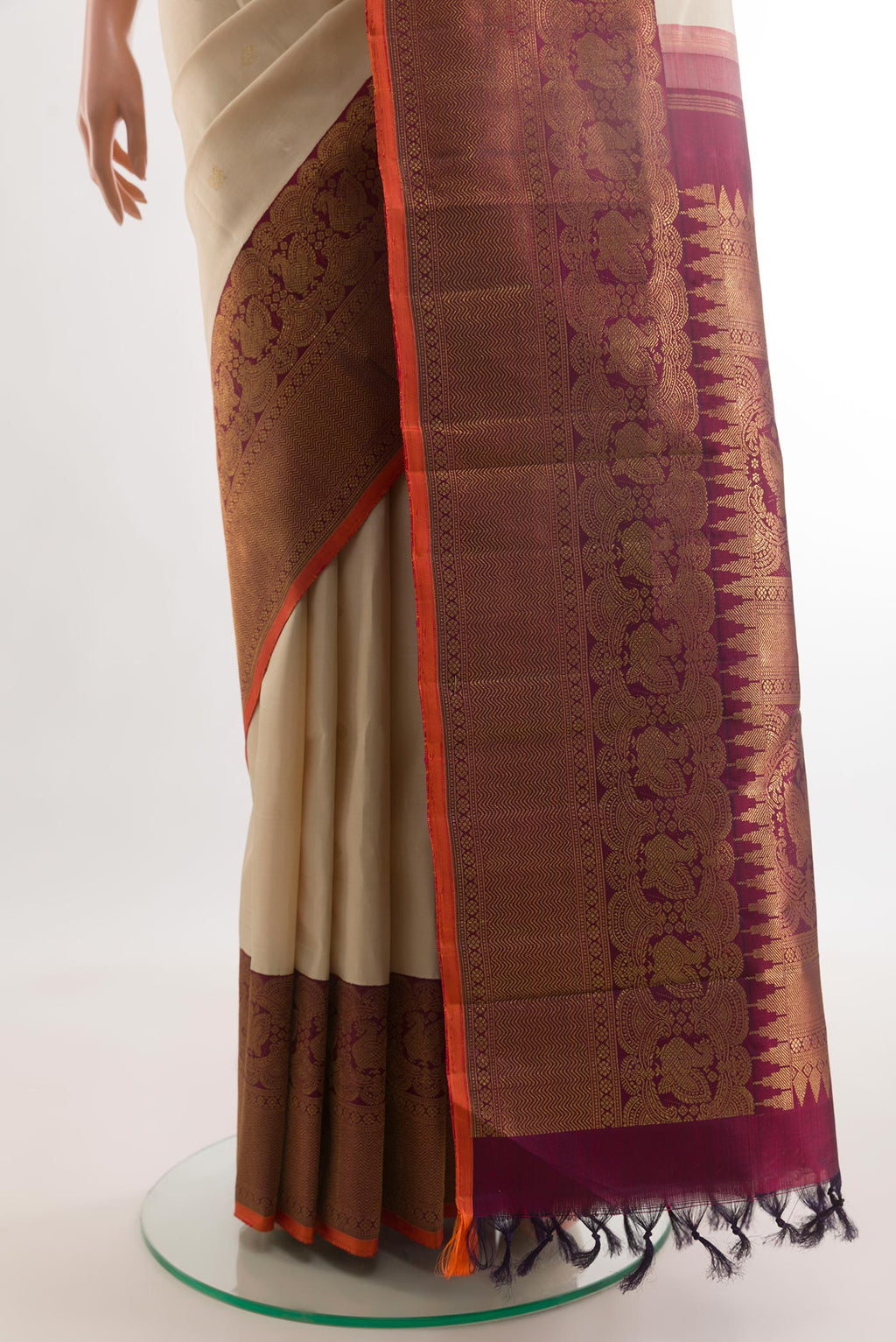 Pleats and pallu of Off White Kanchipuram Silk Saree with Zari Butta on the body and Zari Border. 