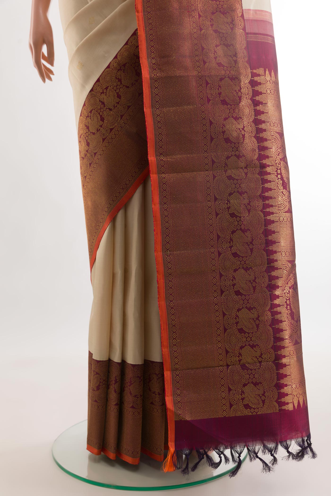 Pleats and pallu of Off White Kanchipuram Silk Saree with Zari Butta on the body and Zari Border. 
