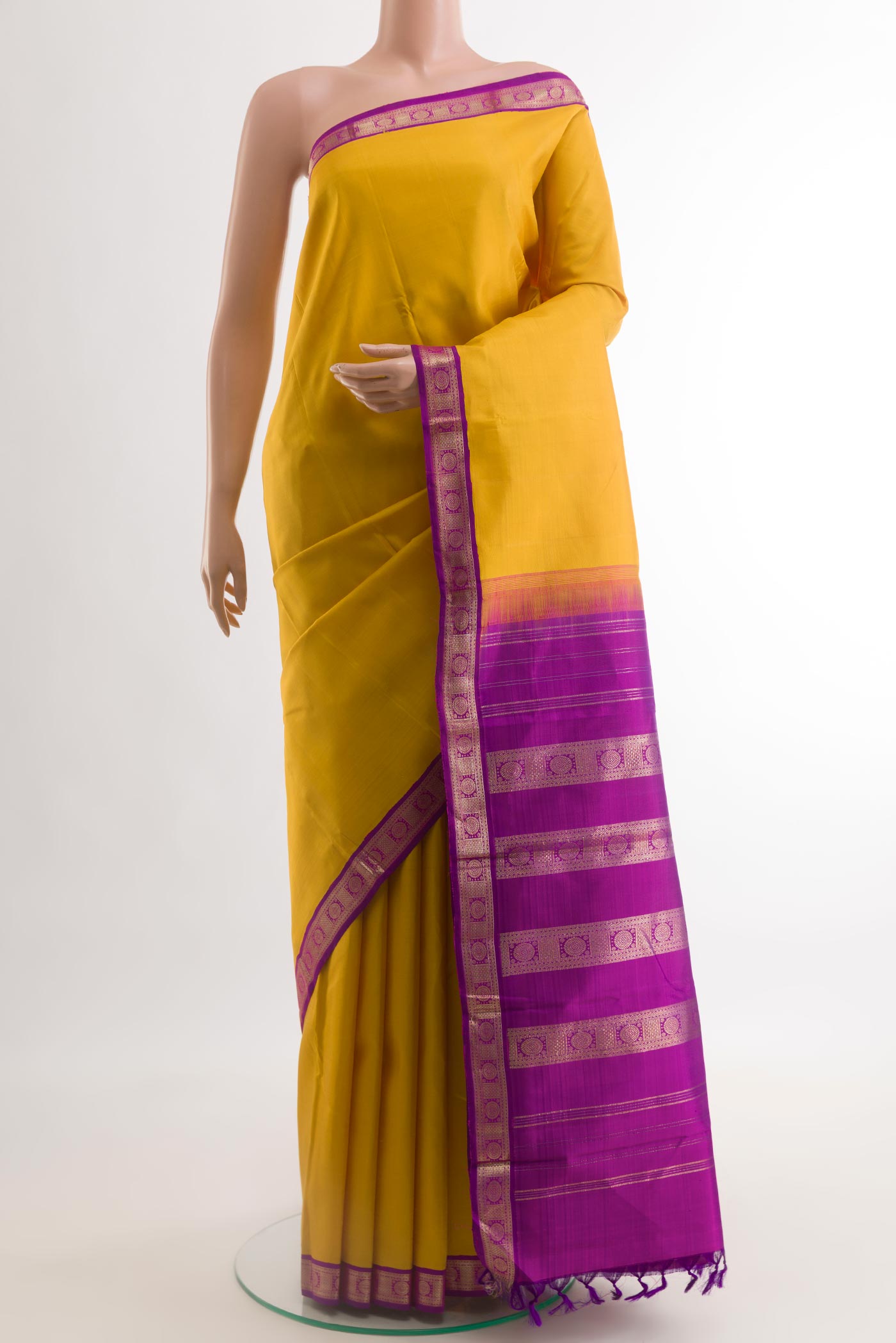 Yellow Kanjivaram Silk Saree with Plain Body and Zari Border.  displayed on a mannequin