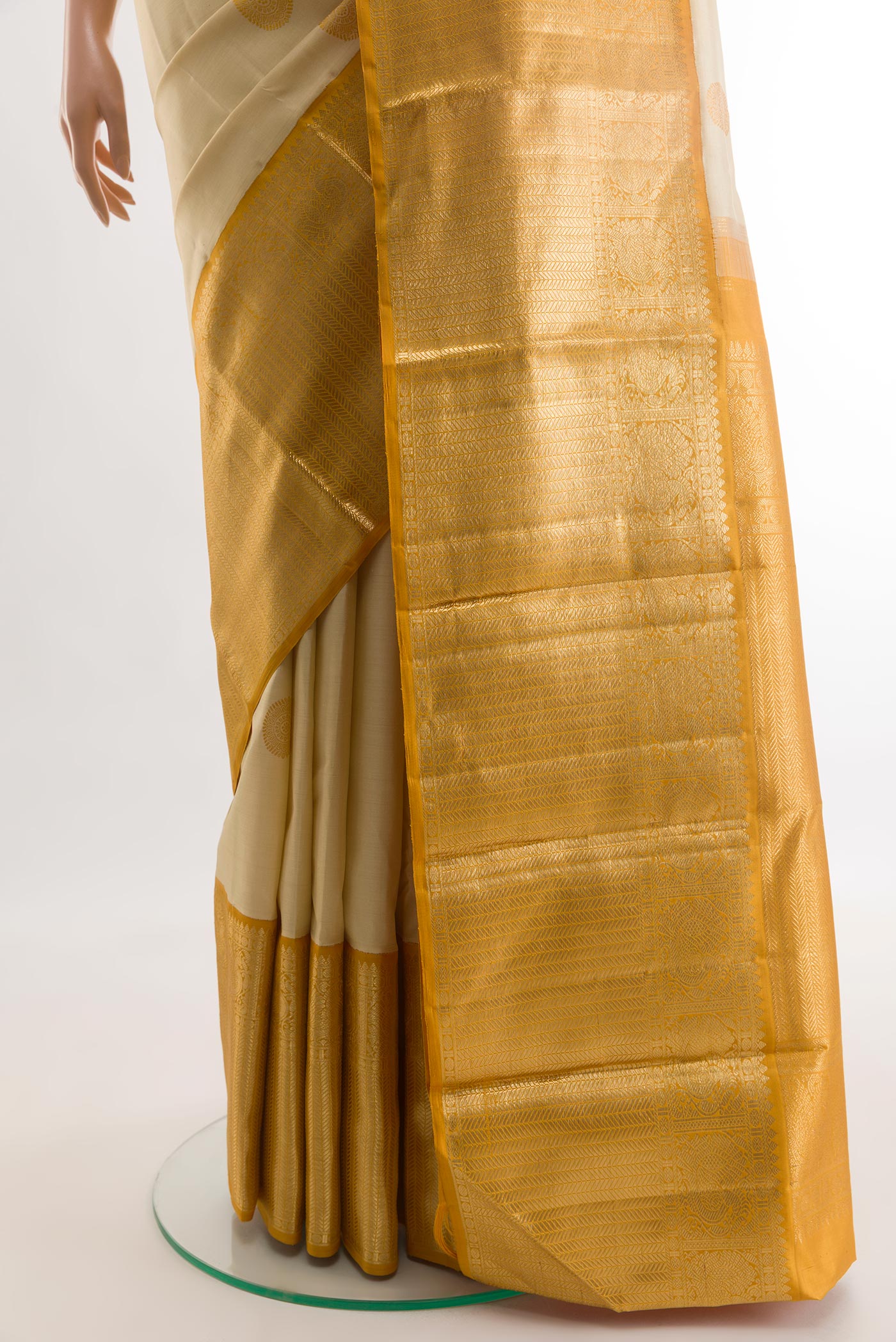 Pleats and pallu of Cream Kanjivaram Silk Saree with Thread Butta on the body and Zari Border. 