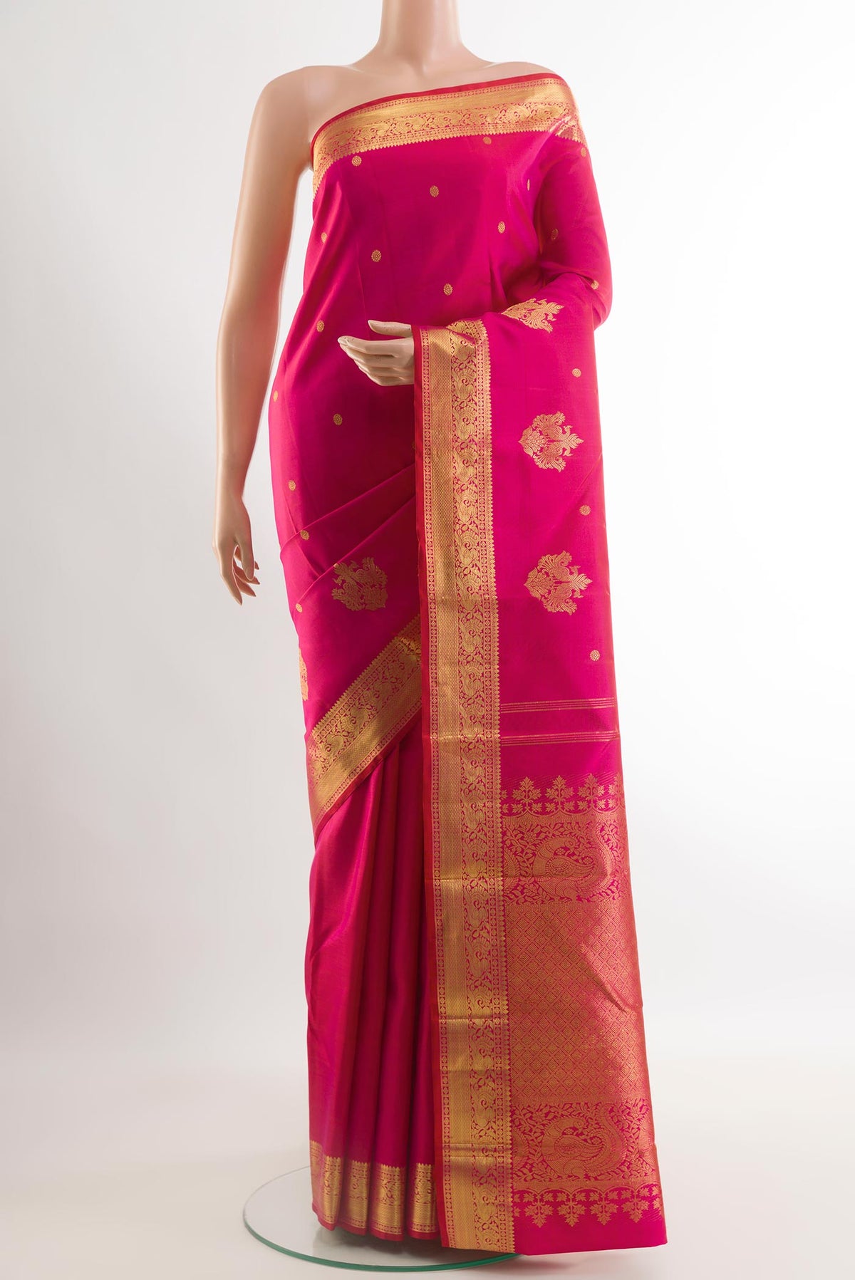 Pink Kanjivaram Silk Saree with Zari Butta on the body and Zari Border.  displayed on a mannequin