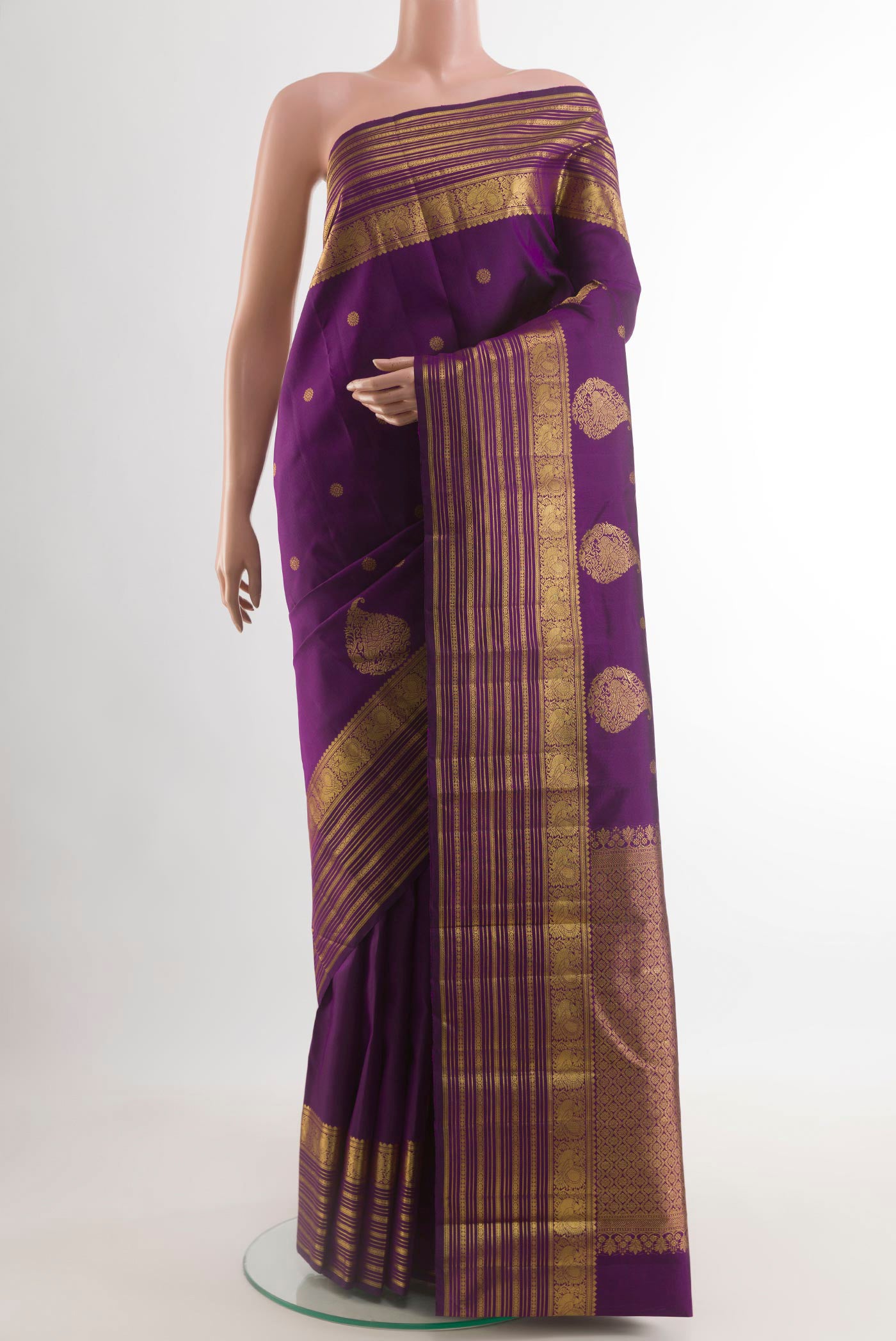 Purple Kanjivaram Silk Saree with Zari Butta on the body and Zari Border.  displayed on a mannequin
