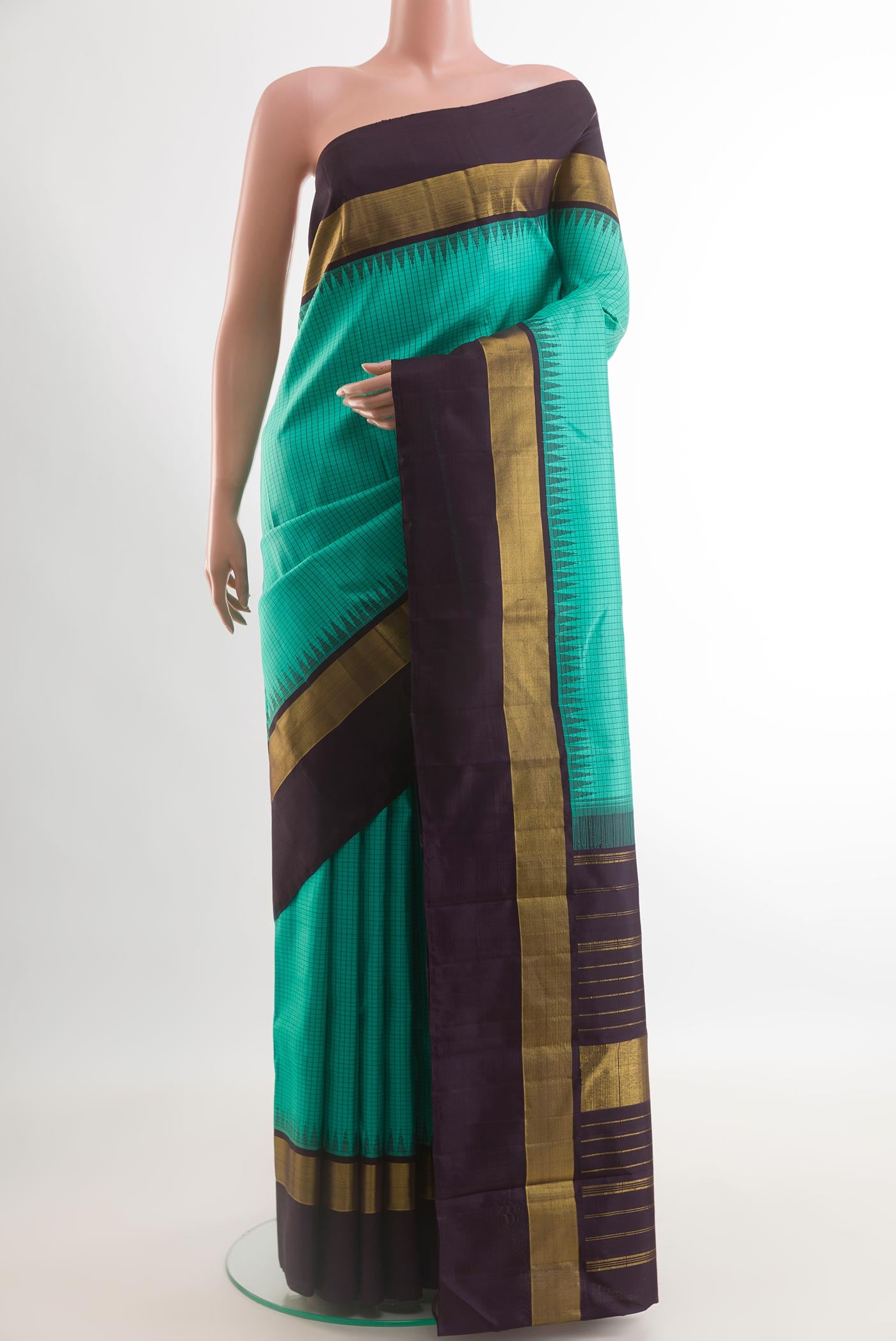 Sea Green Kanjivaram Silk Saree with Checked design on the body and Zari Border.  displayed on a mannequin