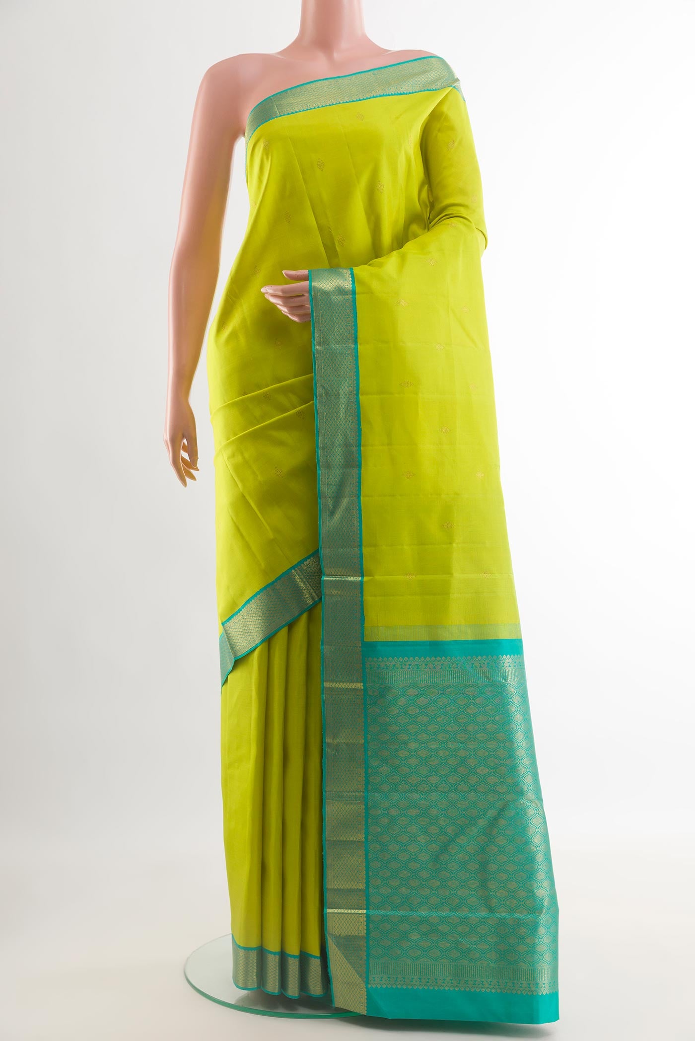 Parrot Green Kanjivaram Silk Saree with Zari Butta on the body and Zari Border.  displayed on a mannequin