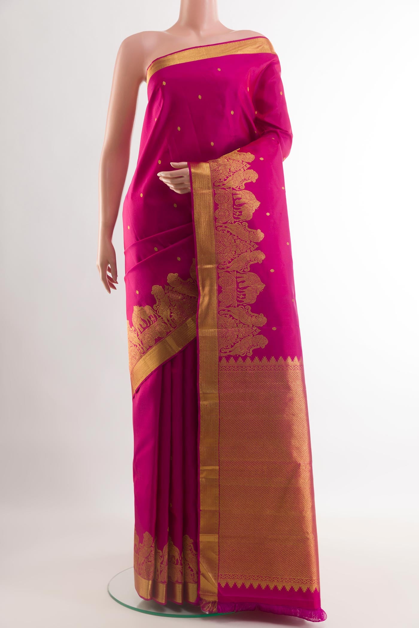 Rani Pink Kanjivaram Silk Saree with Zari Butta on the body and Zari Border.  displayed on a mannequin