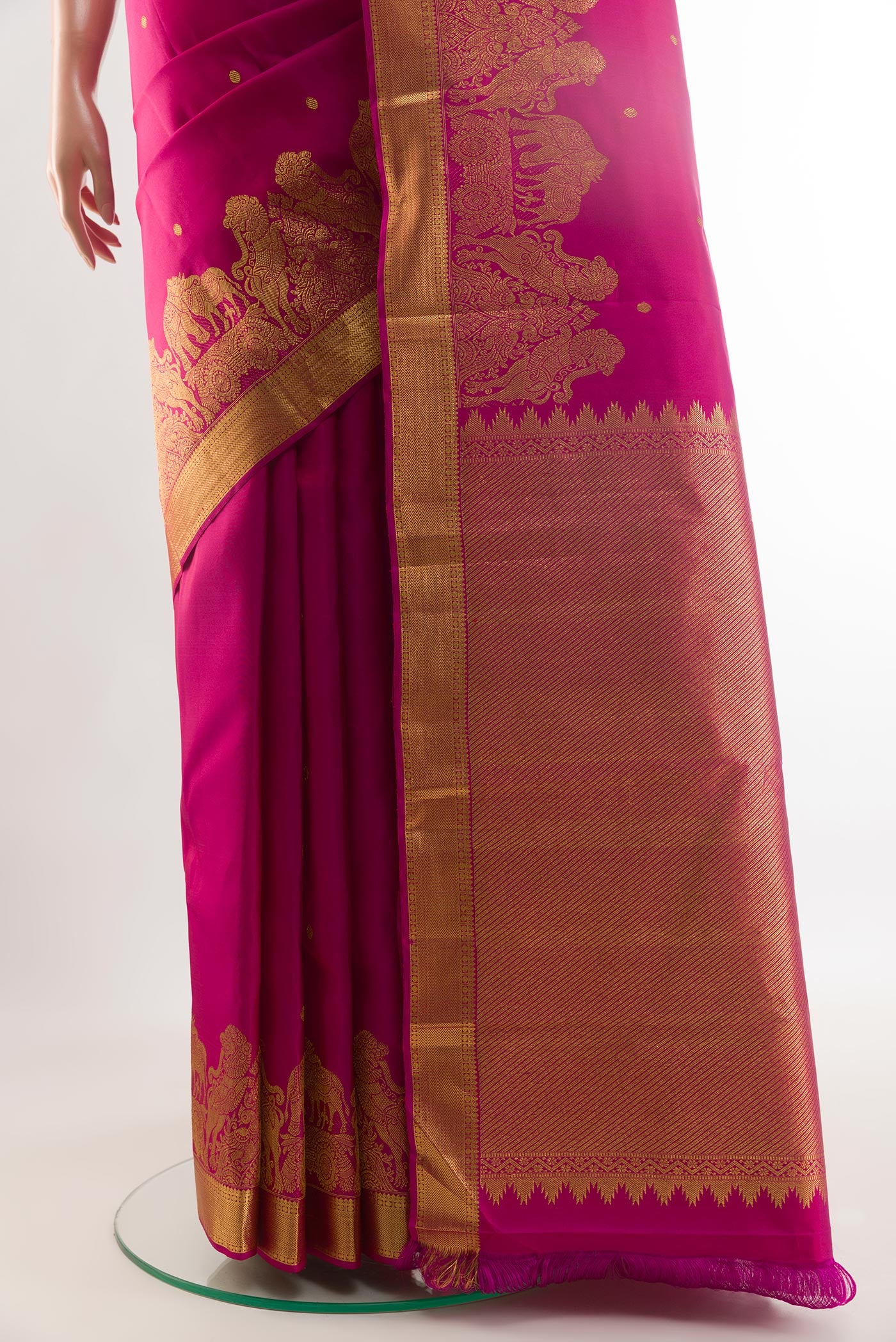 Pleats and pallu of Rani Pink Kanjivaram Silk Saree with Zari Butta on the body and Zari Border. 