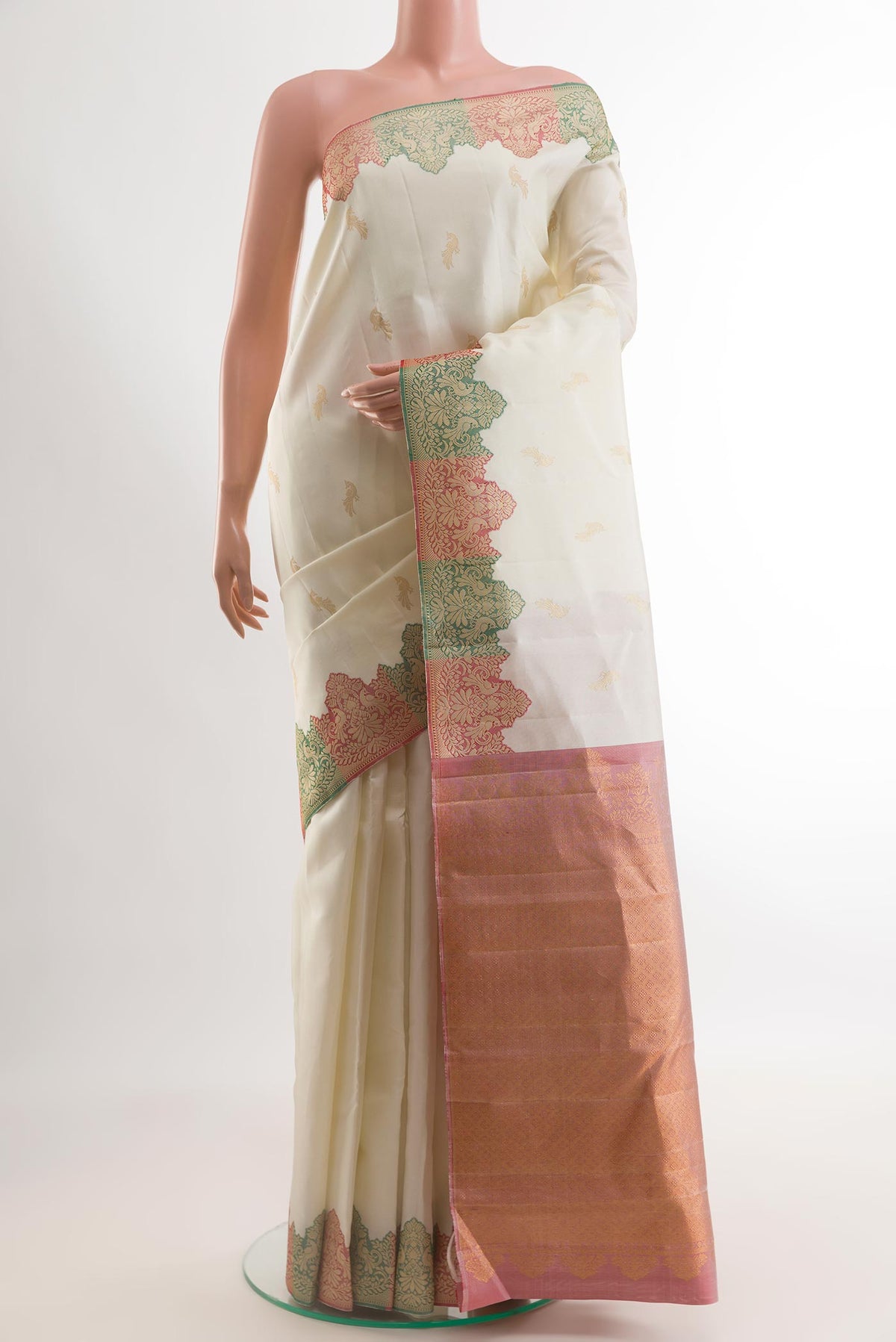 Off White Kanchipuram Silk Saree with Zari Butta on the body and Fancy Border.  displayed on a mannequin