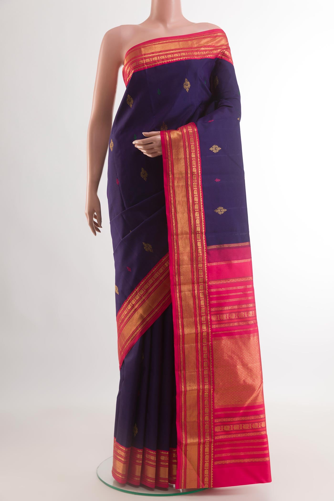 Navy Blue Kanjivaram Silk Saree with Zari And Thread Butta on the body and Zari Border.  displayed on a mannequin