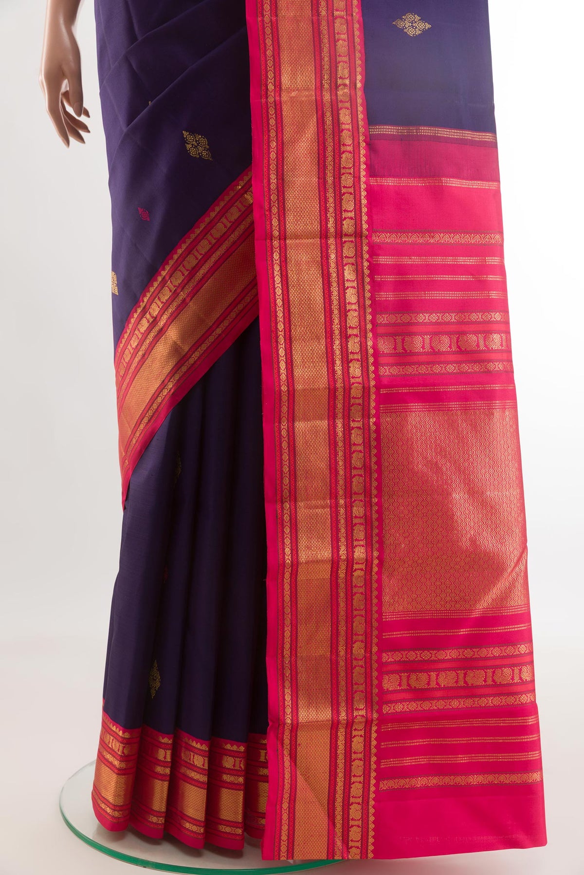 Pleats and pallu of Navy Blue Kanjivaram Silk Saree with Zari And Thread Butta on the body and Zari Border. 