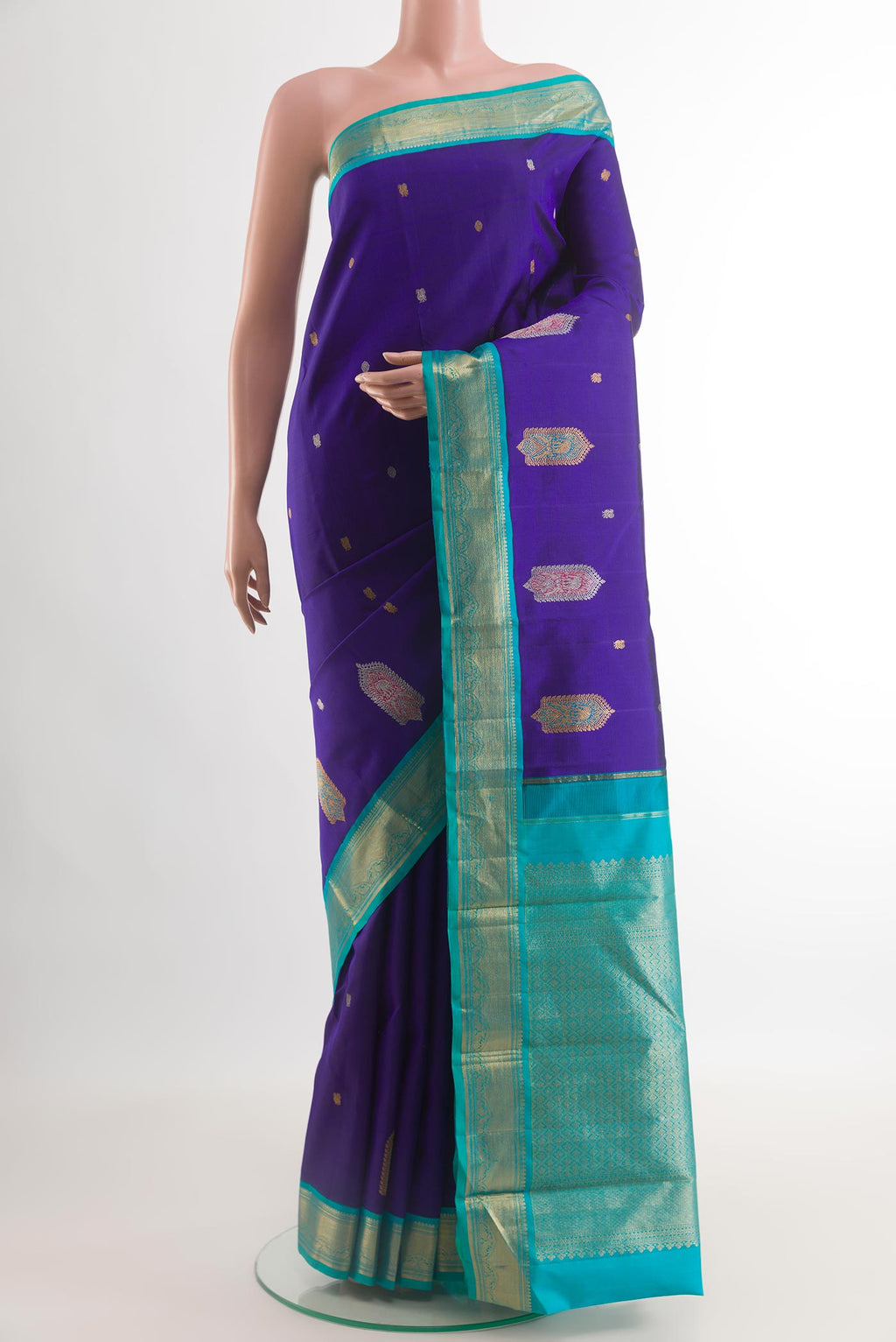 Blue Kanjivaram Silk Saree with Zari Butta on the body and Zari Border.  displayed on a mannequin