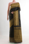 Black Kanjivaram Silk Saree with Zari Butta on the body and Zari Border.  displayed on a mannequin