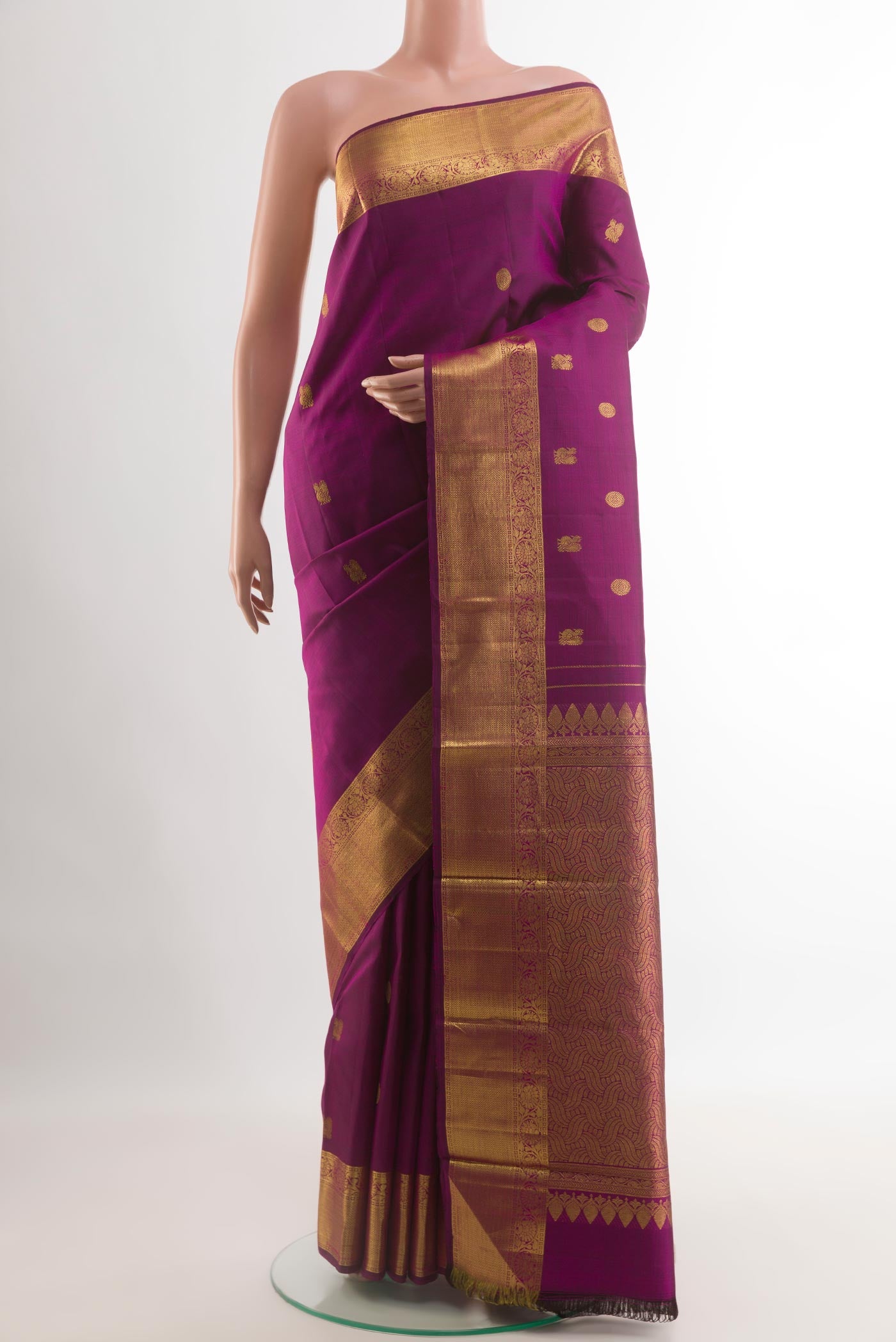 Purple Kanjivaram Silk Saree with Zari Butta on the body and Zari Border.  displayed on a mannequin