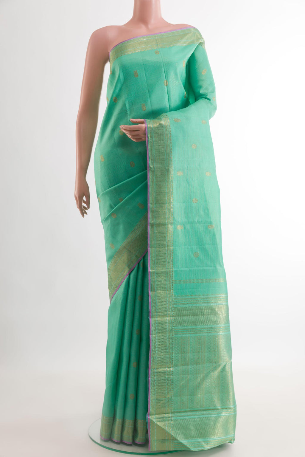 Sea Green Kanjivaram Silk Saree with Zari Butta on the body and Zari Border.  displayed on a mannequin