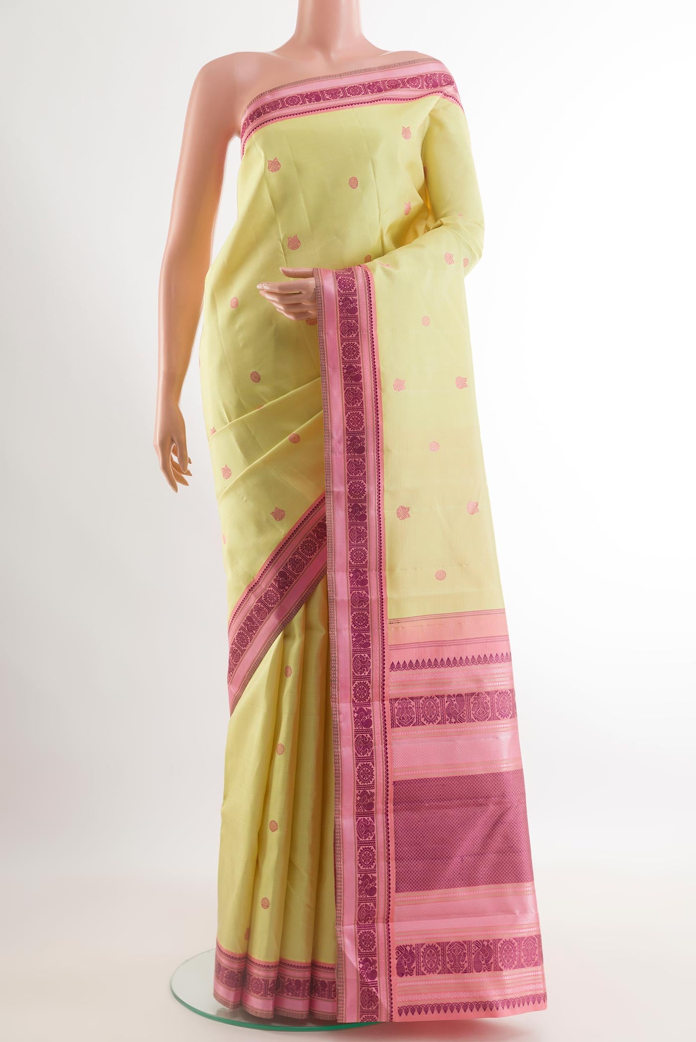 Lemon Yellow Kanjivaram Silk Saree with Thread Butta on the body and Thread Border.  displayed on a mannequin