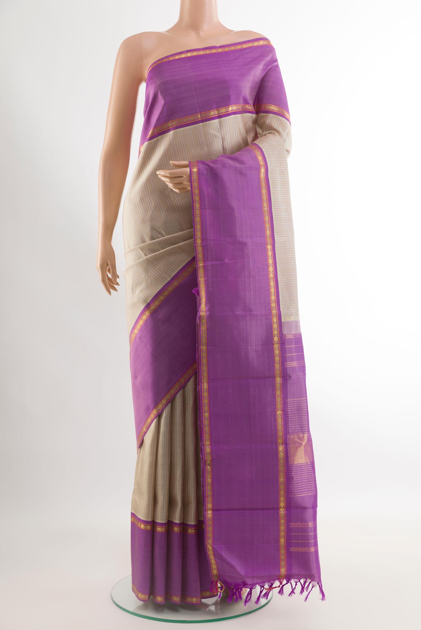 Grey Kanjivaram Silk Saree with Checked design on the body and Zari Border.  displayed on a mannequin
