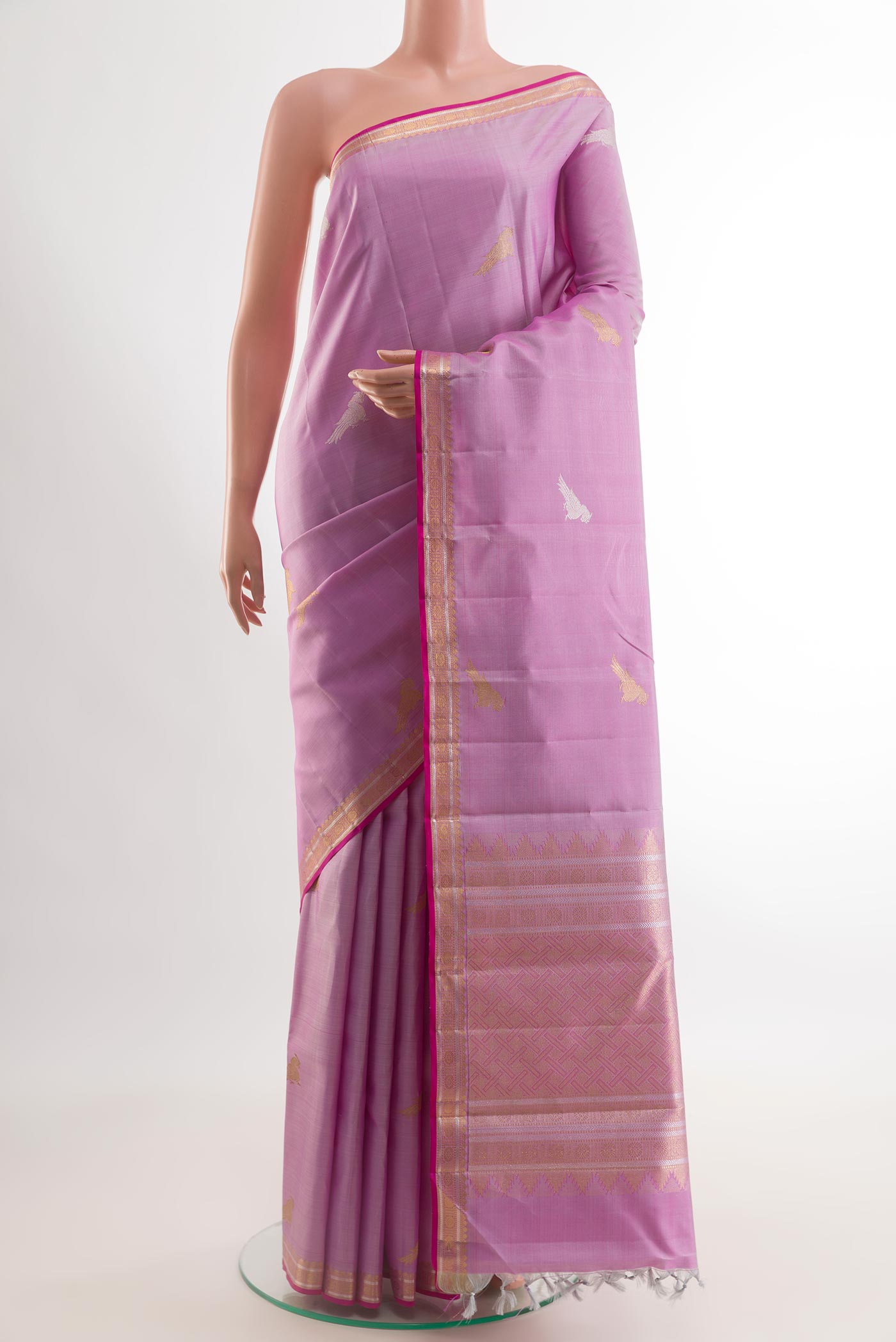 Lavender Kanjivaram Silk Saree with Zari Butta on the body and Zari Border.  displayed on a mannequin