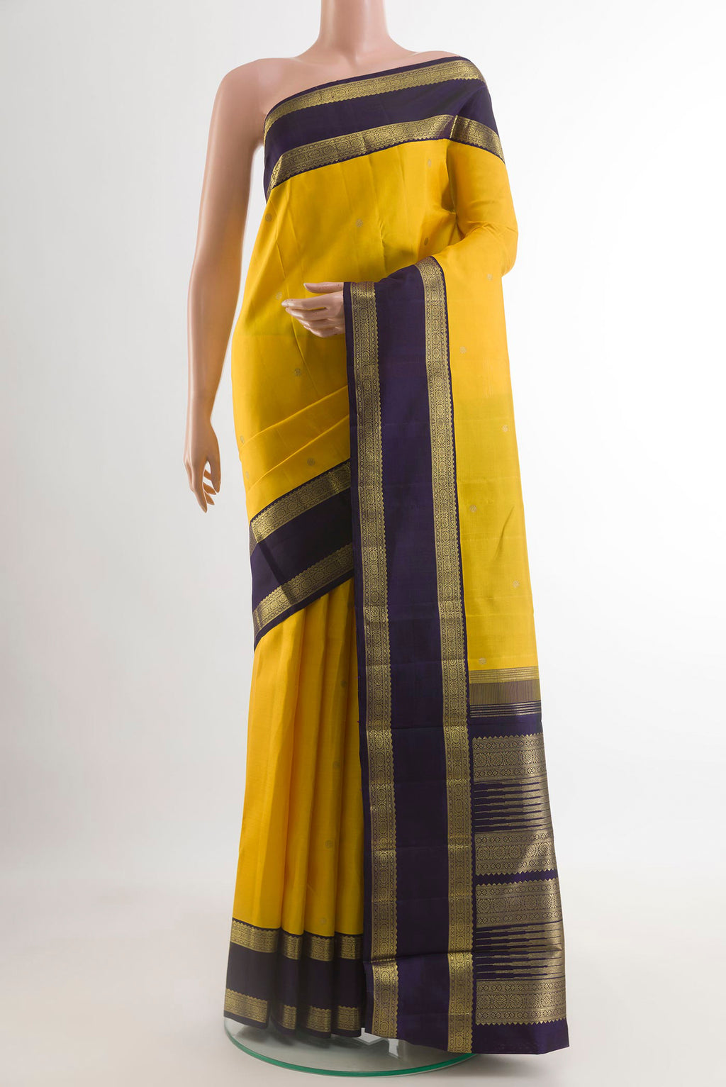 Yellow Kanchipuram Silk Saree with Zari Butta on the body and Zari Border.  displayed on a mannequin