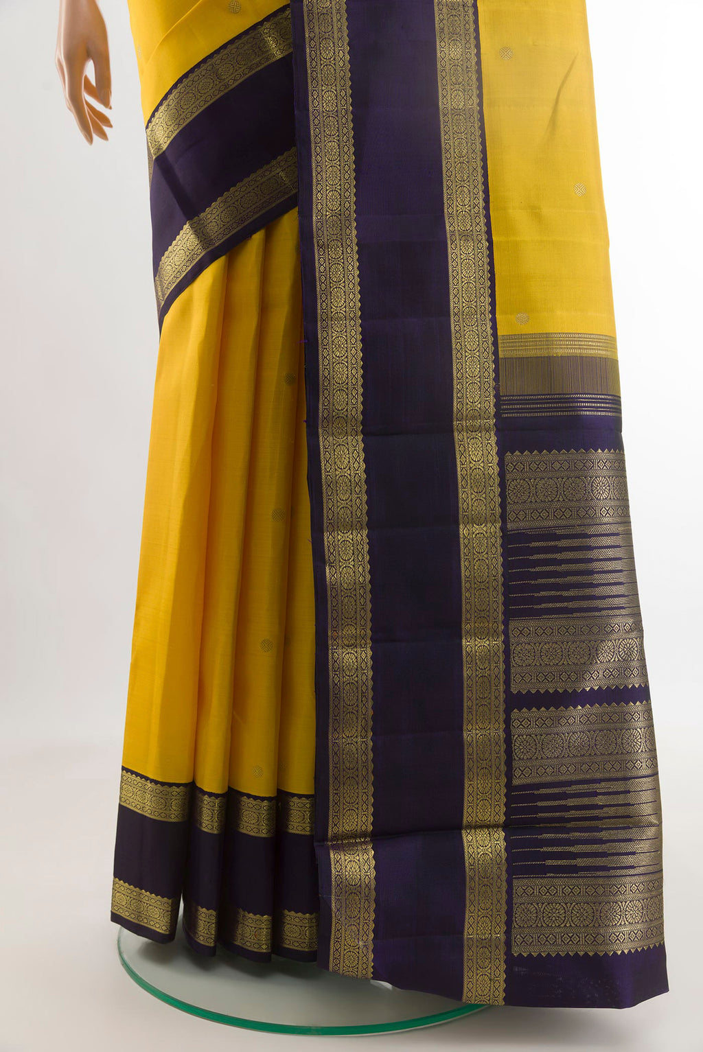 Pleats and pallu of Yellow Kanchipuram Silk Saree with Zari Butta on the body and Zari Border. 