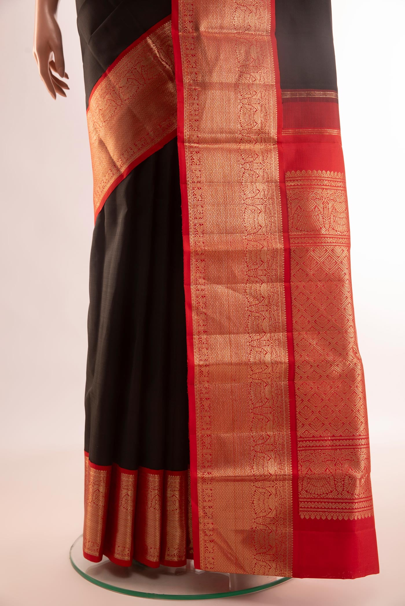 Pleats and pallu of Black Kanjivaram Silk Saree with Plain Body and Zari Border. 