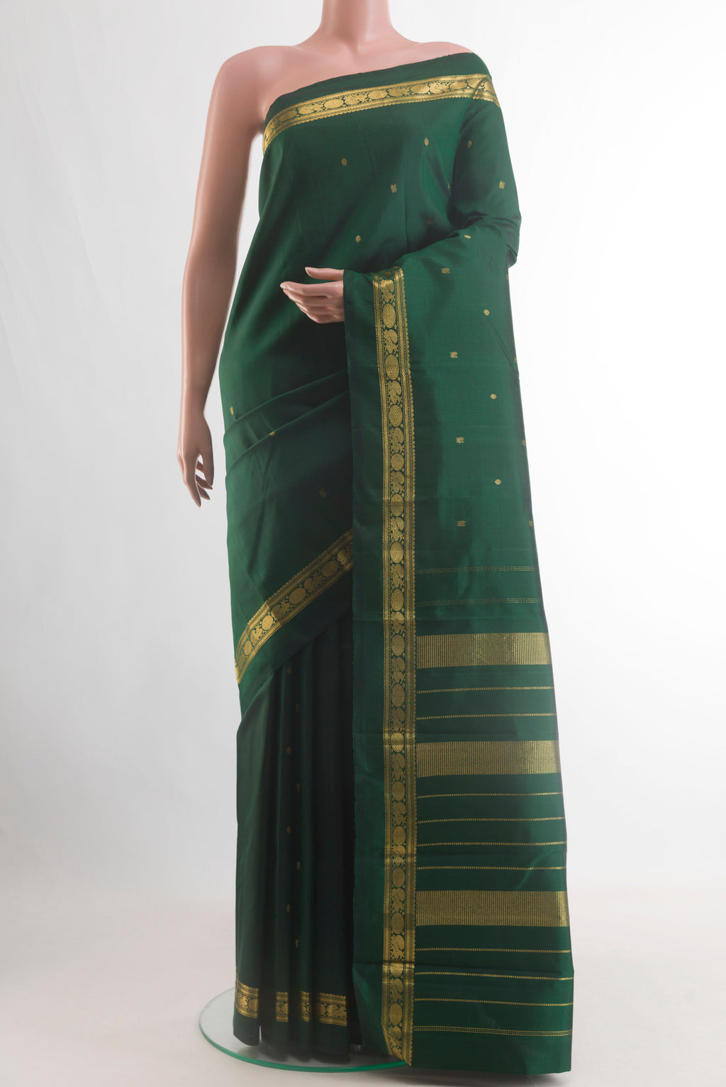 Pure Silk Bottle Green Kanchipuram Saree with Zari Butta on the body and Zari Border.  displayed on a mannequin