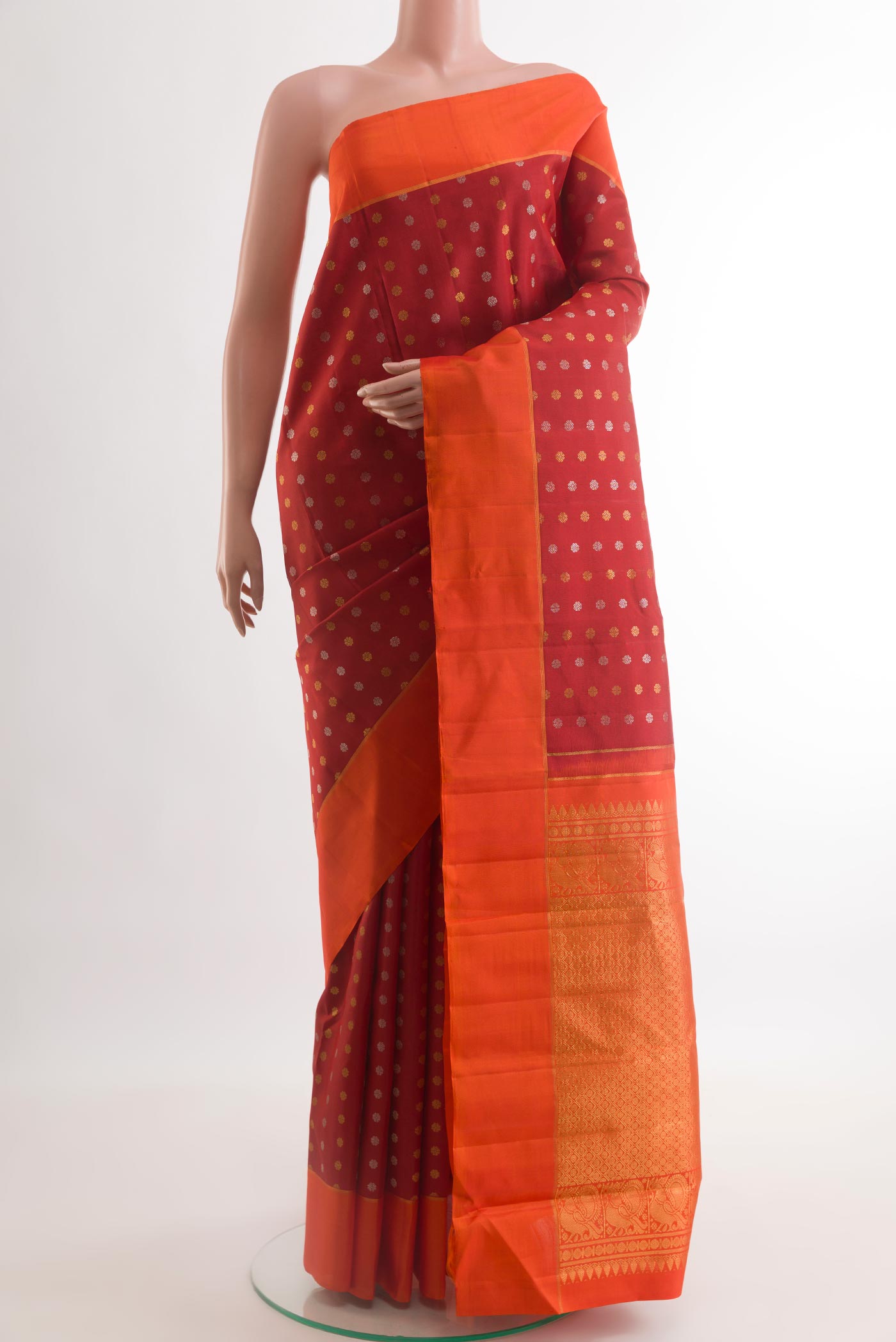 Maroon Kanchipuram Silk Saree with Zari Butta on the body and Plain Border.  displayed on a mannequin