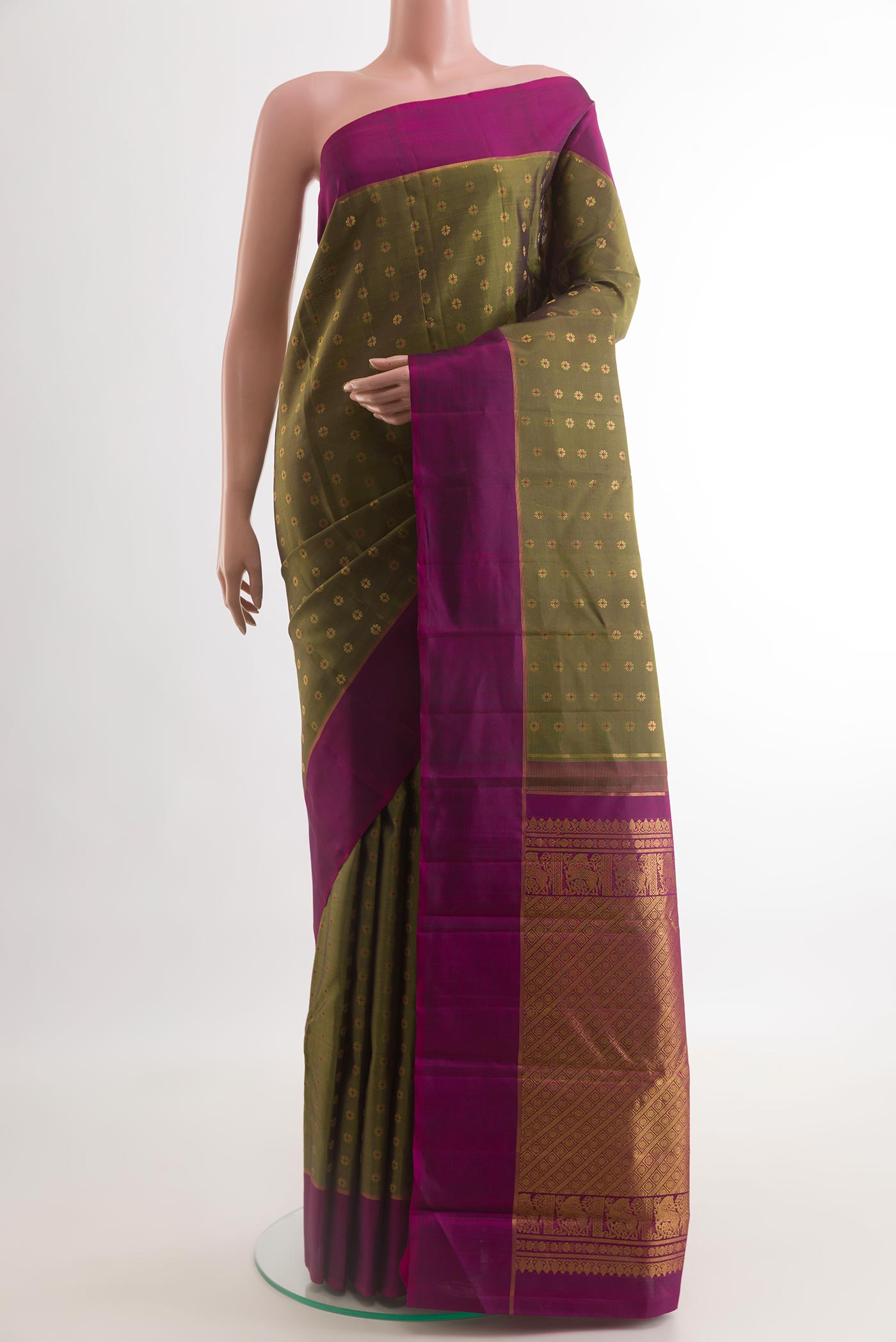 Mehandi Green Kanchipuram Silk Saree with Zari Butta on the body and Zari Border.  displayed on a mannequin