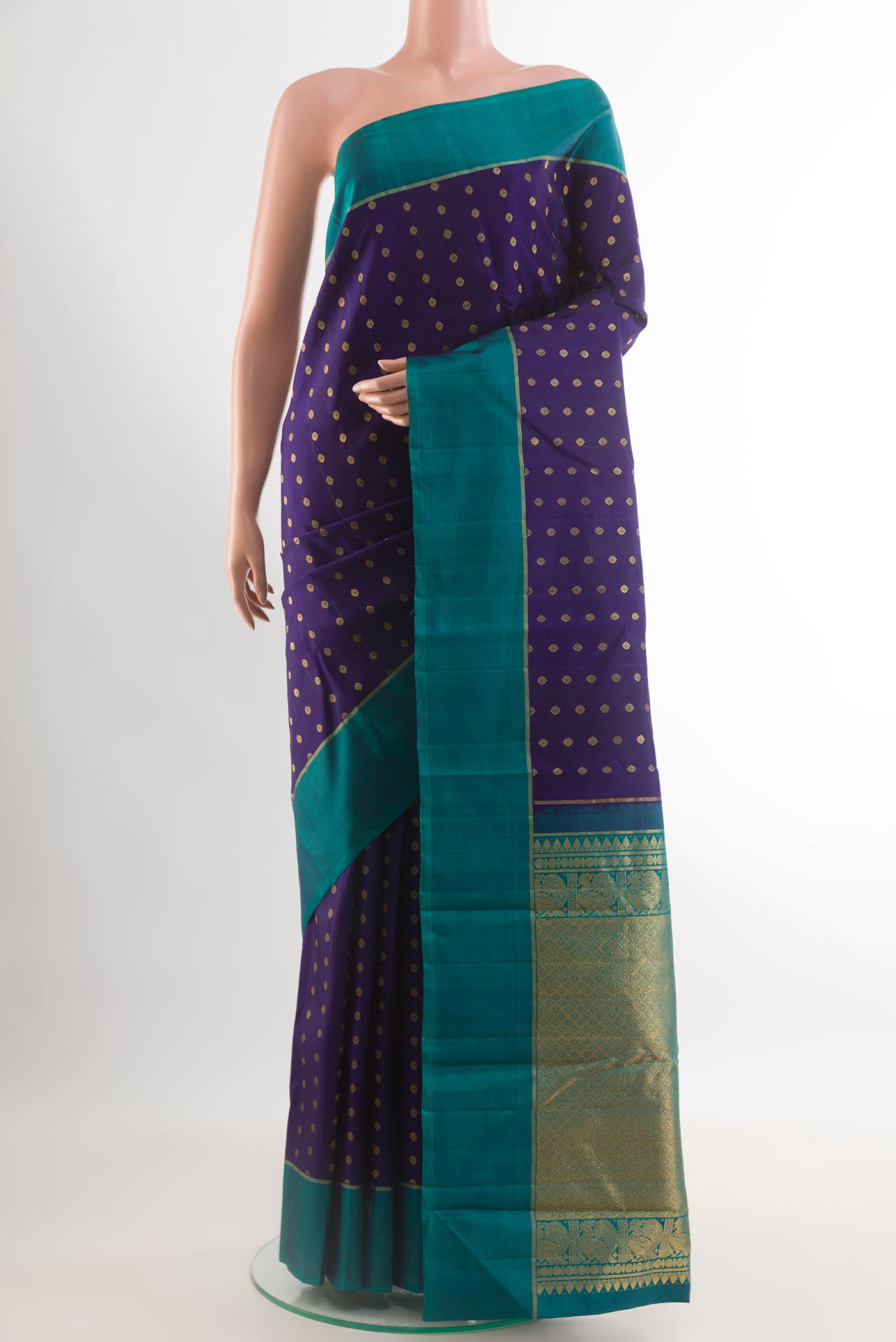 Navy Blue Kanchipuram Silk Saree with Zari Butta on the body and Zari Border.  displayed on a mannequin