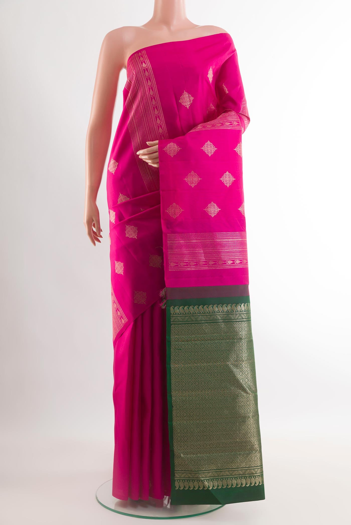 Rani Pink Kanchipuram Silk Saree with Zari Butta on the body and Without Border.  displayed on a mannequin
