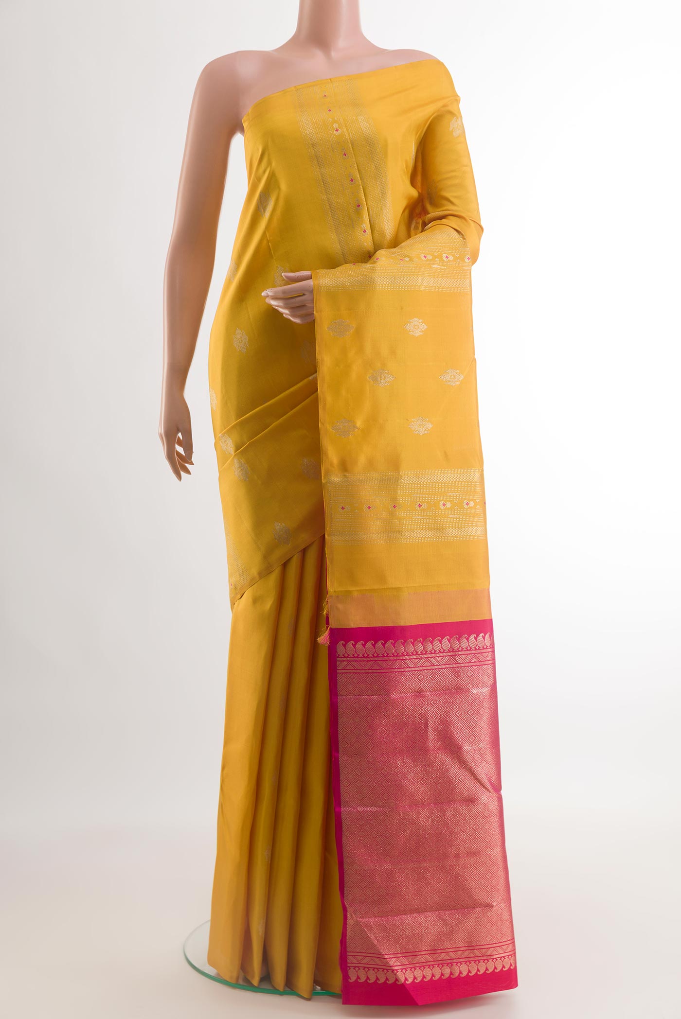 Yellow Kanchipuram Silk Saree with Zari Butta on the body and Without Border.  displayed on a mannequin