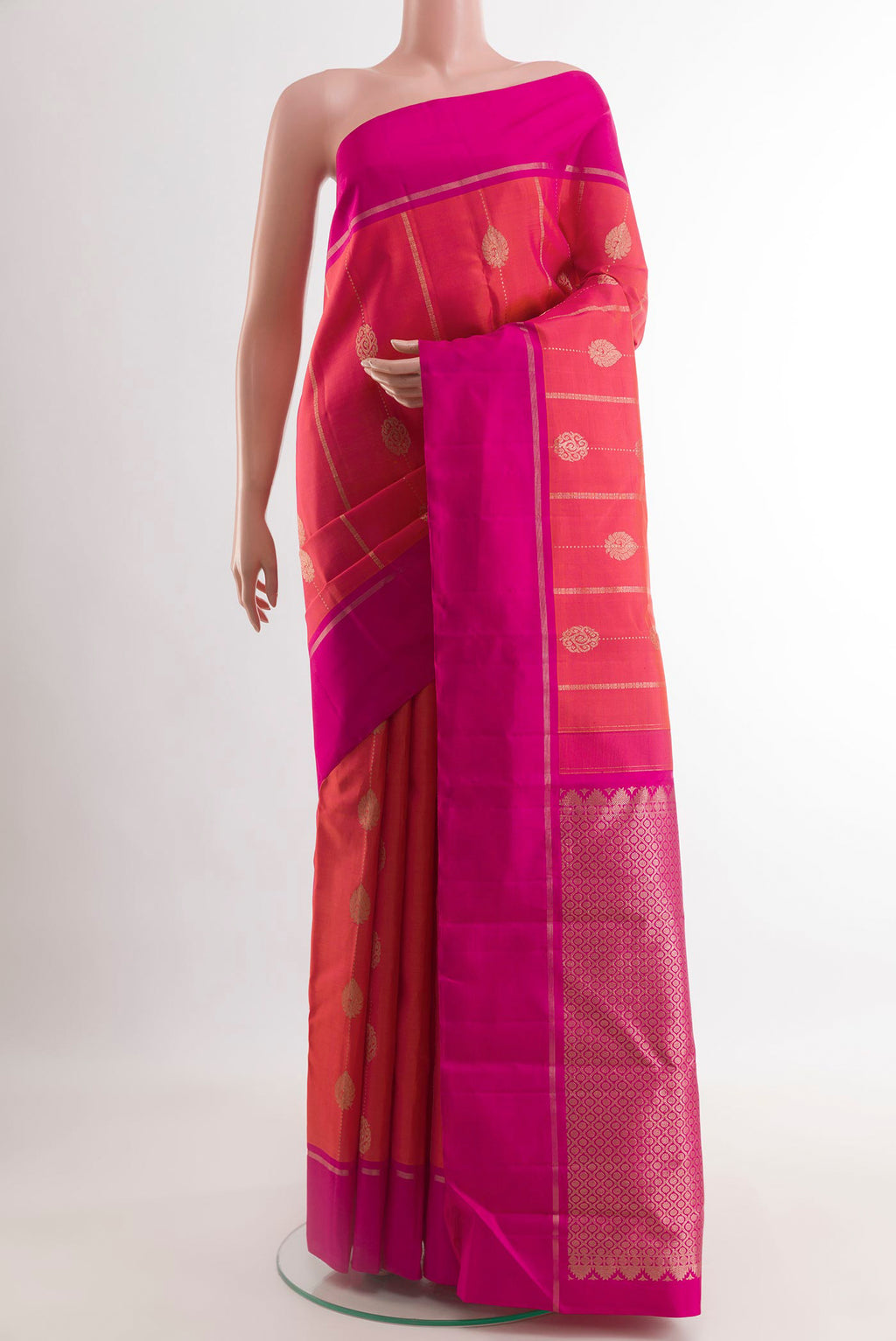 Pink with Orange Color Kanjivaram Silk Saree with Zari Butta on the body and Zari Border.  displayed on a mannequin