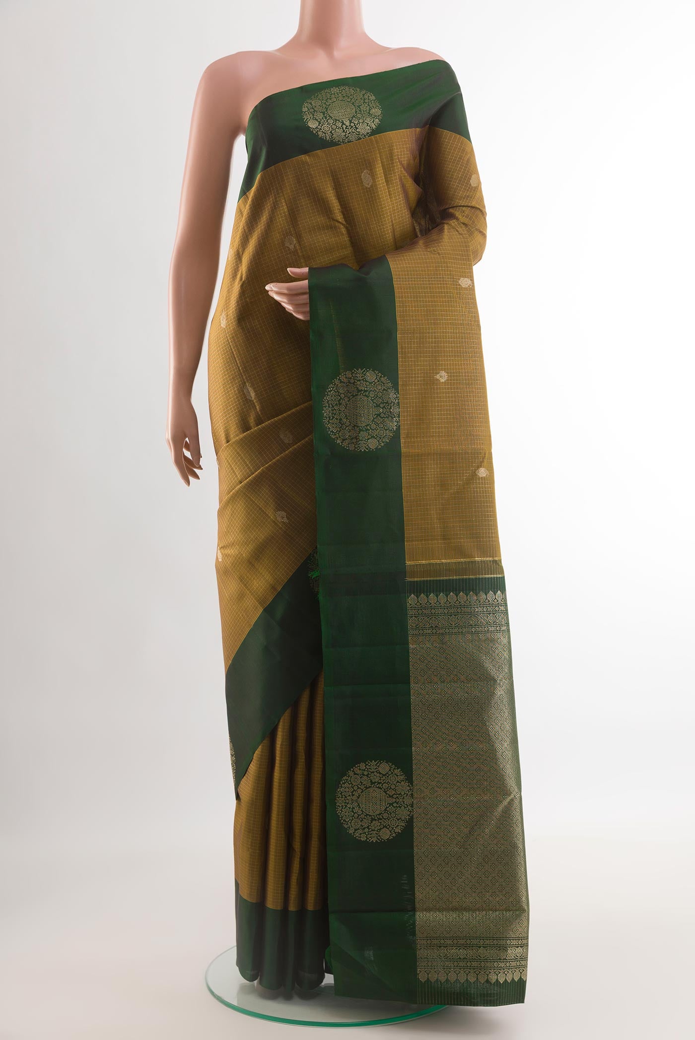 Mehandi Green Kanjivaram Silk Saree with Zari Butta on the body and Zari Border.  displayed on a mannequin